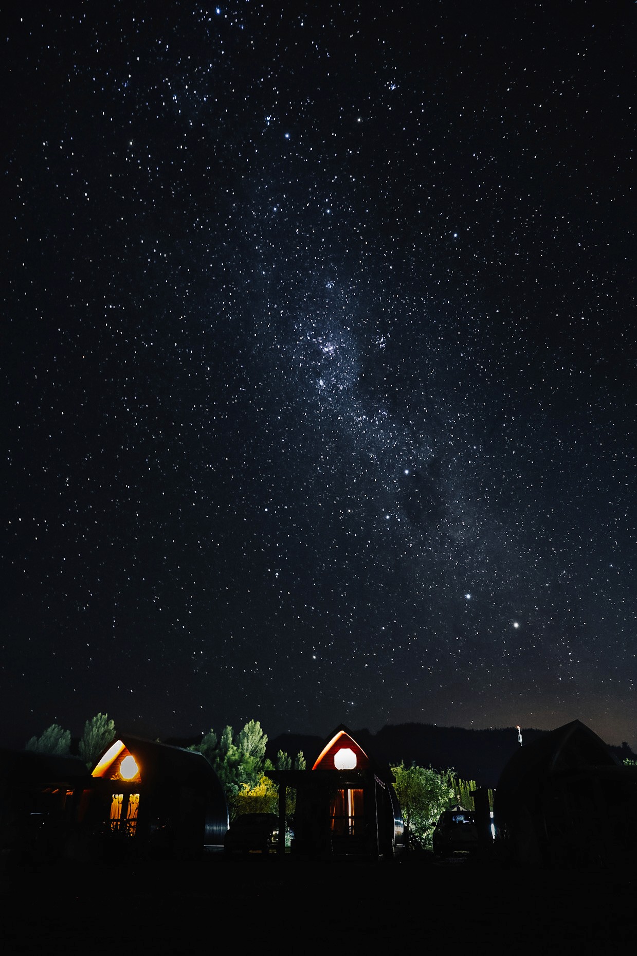 A hut with a starry sky in the background