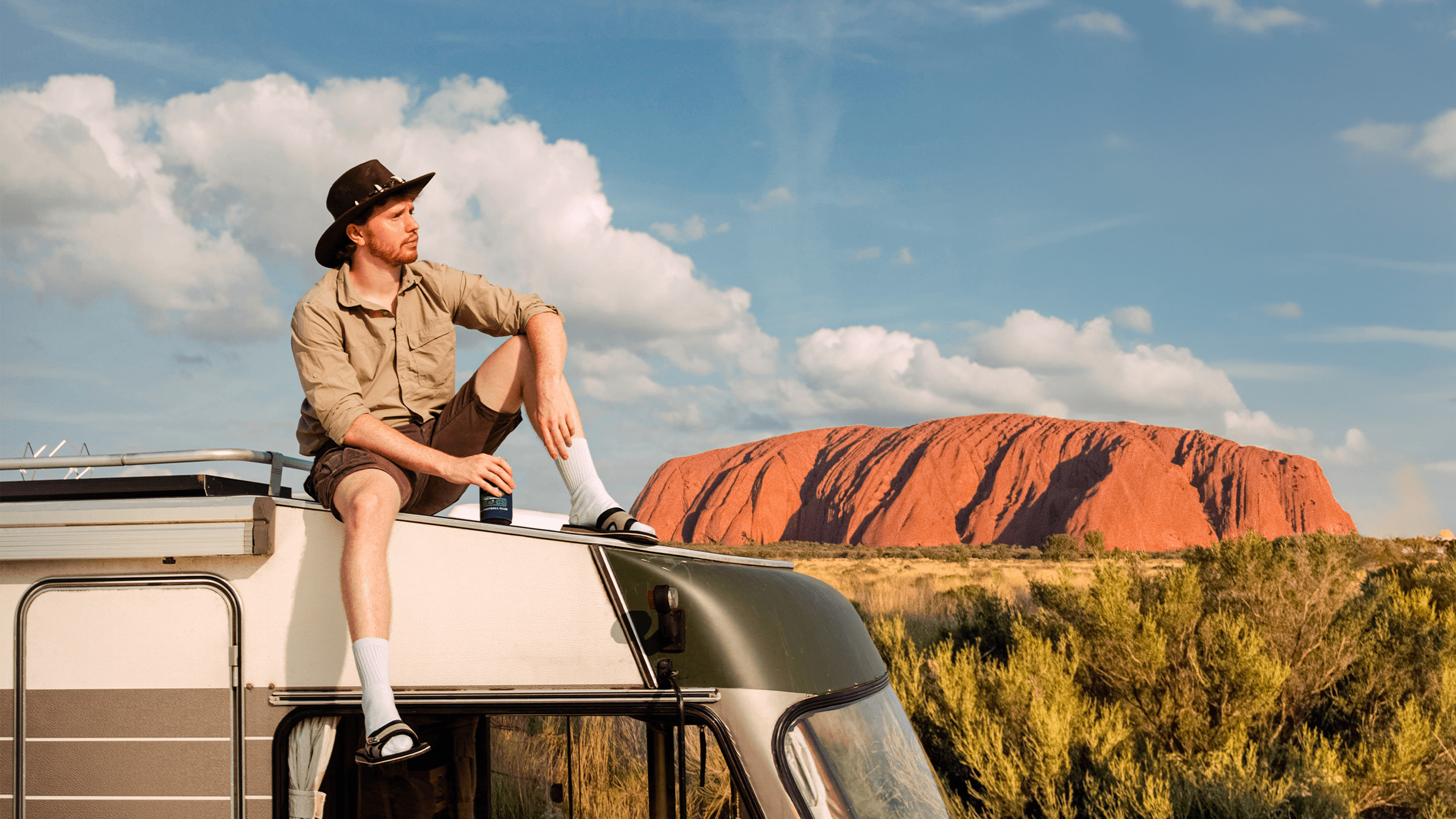 Close-up of a person with braided buns, sunglasses, and a leather jacket, set against a gradient background for a dramatic effect.