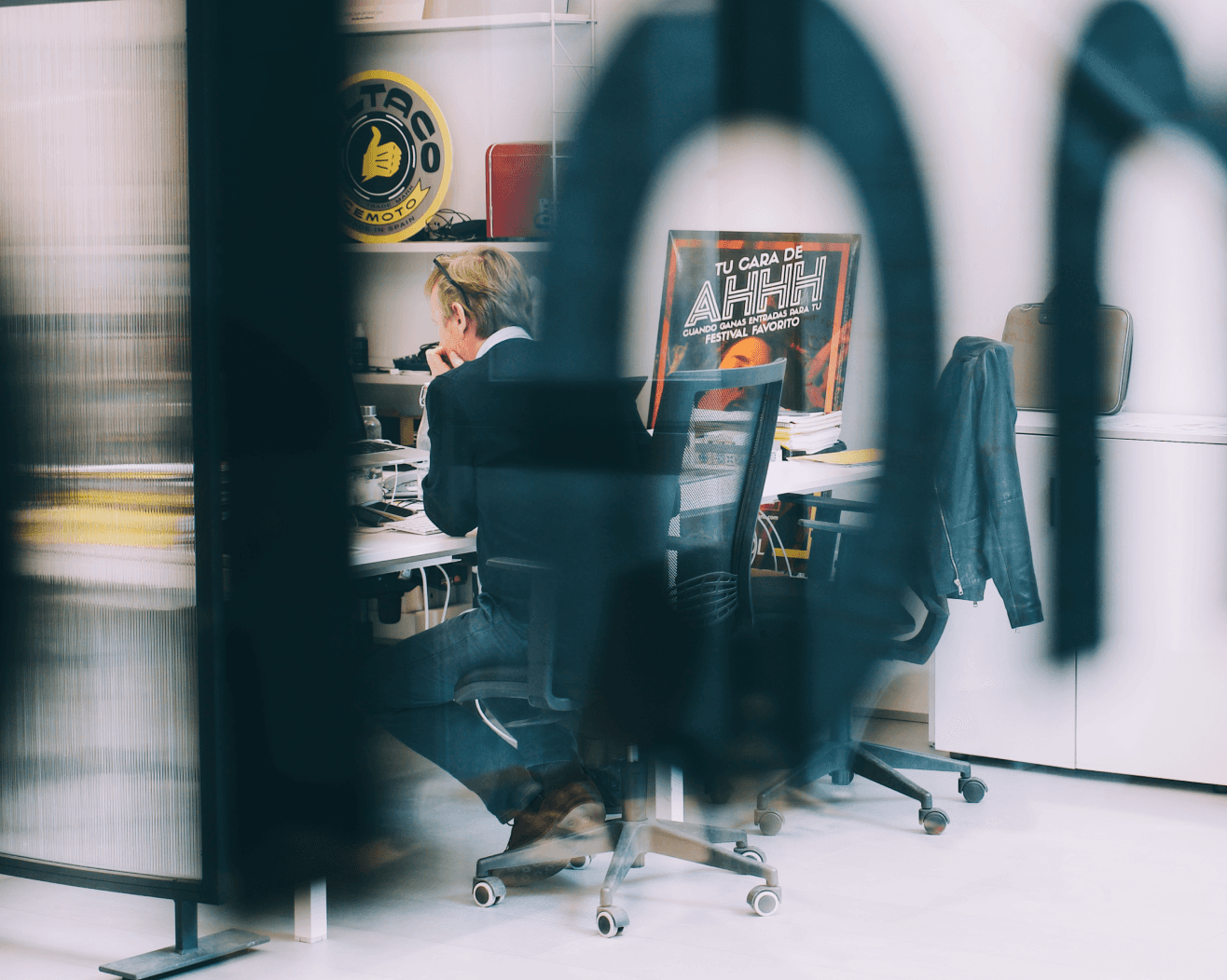 Young black woman witting at the table working on a laptop