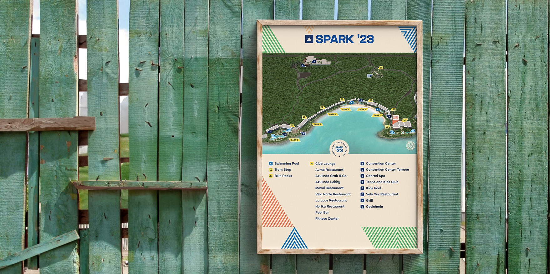 Photo of an event map in a wooden frame hanging on a wooden fence outdoors. 