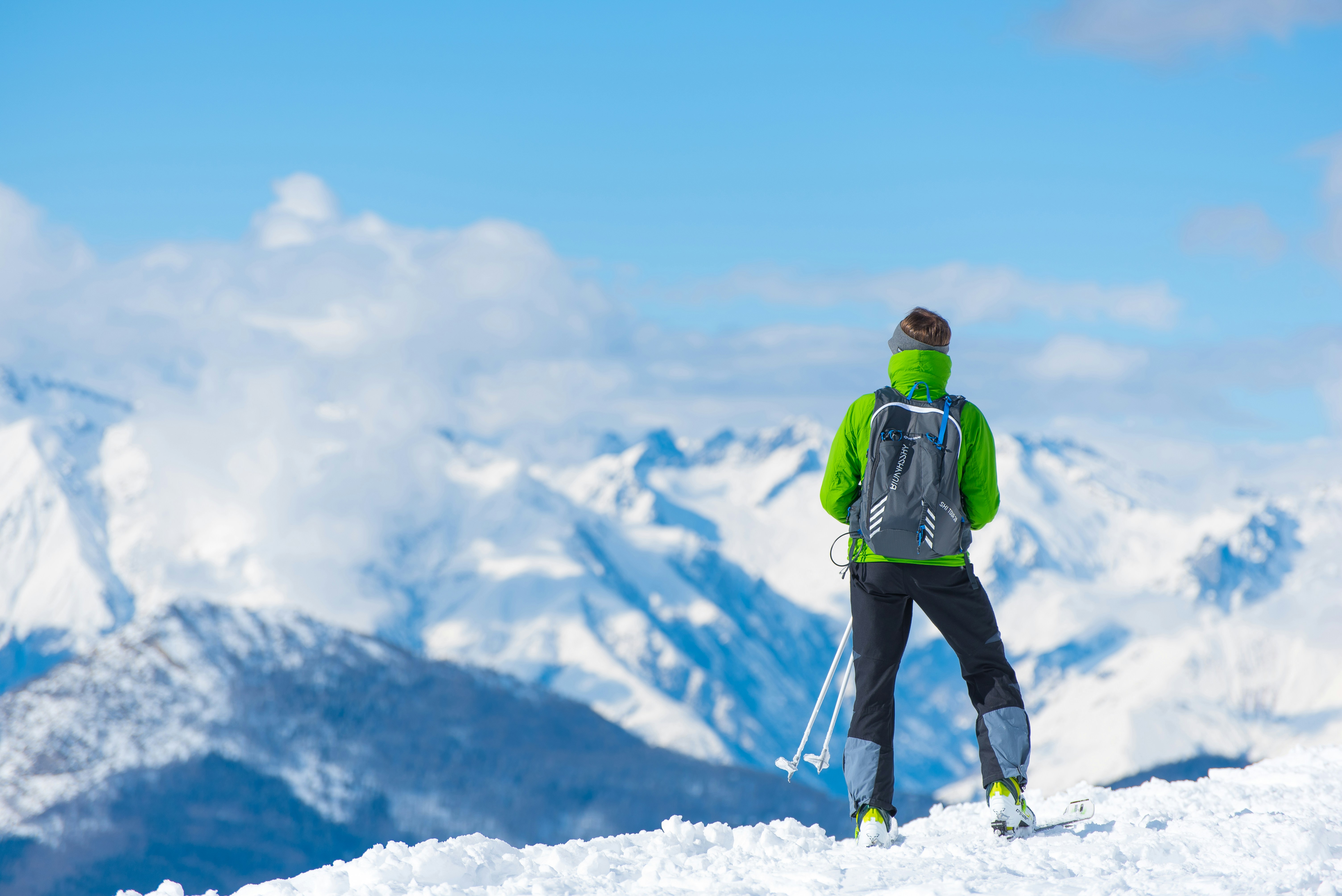 A Person Standing Over a Beautiful View of the Mountains After Skiing