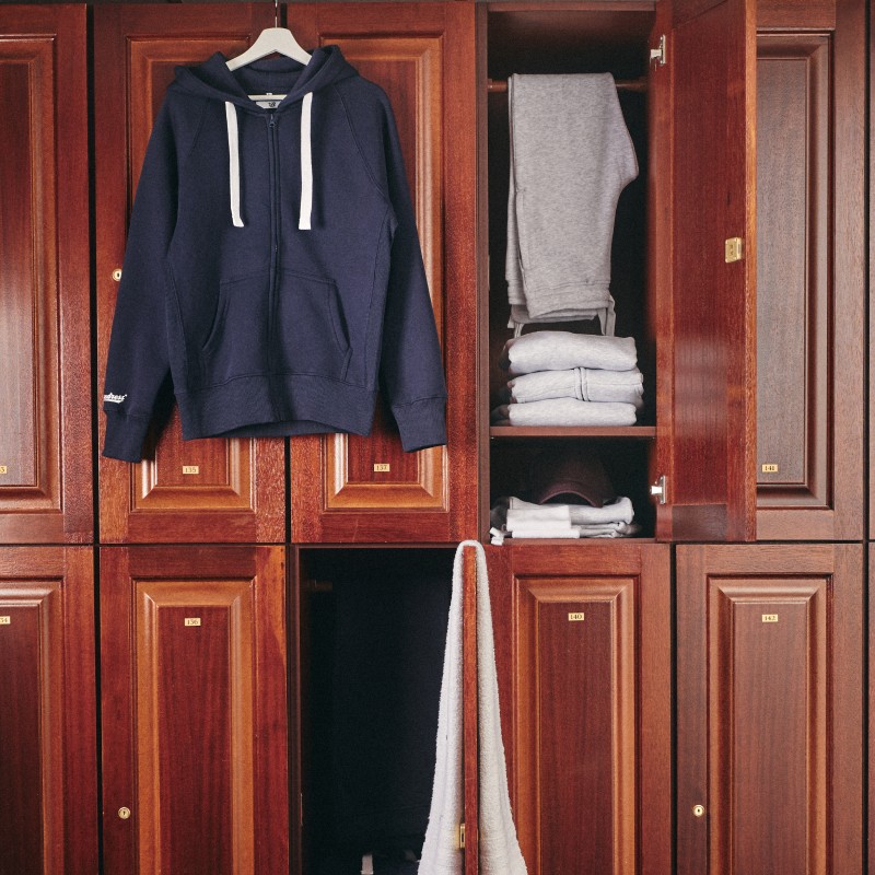 Locker room closets with different russemerch garments hanging on them