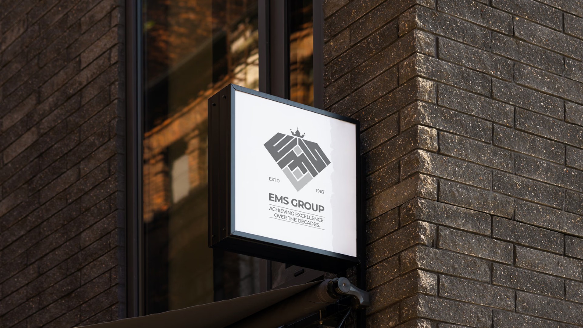 EMS Group logo on outdoor signage — diamond jewelry brand identity by Penguincil Design