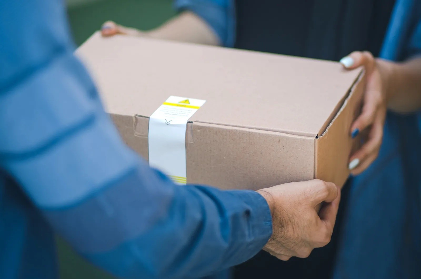Courier handing a package to a client