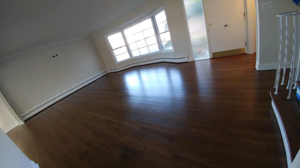 Refinished hardwood flooring in an open room