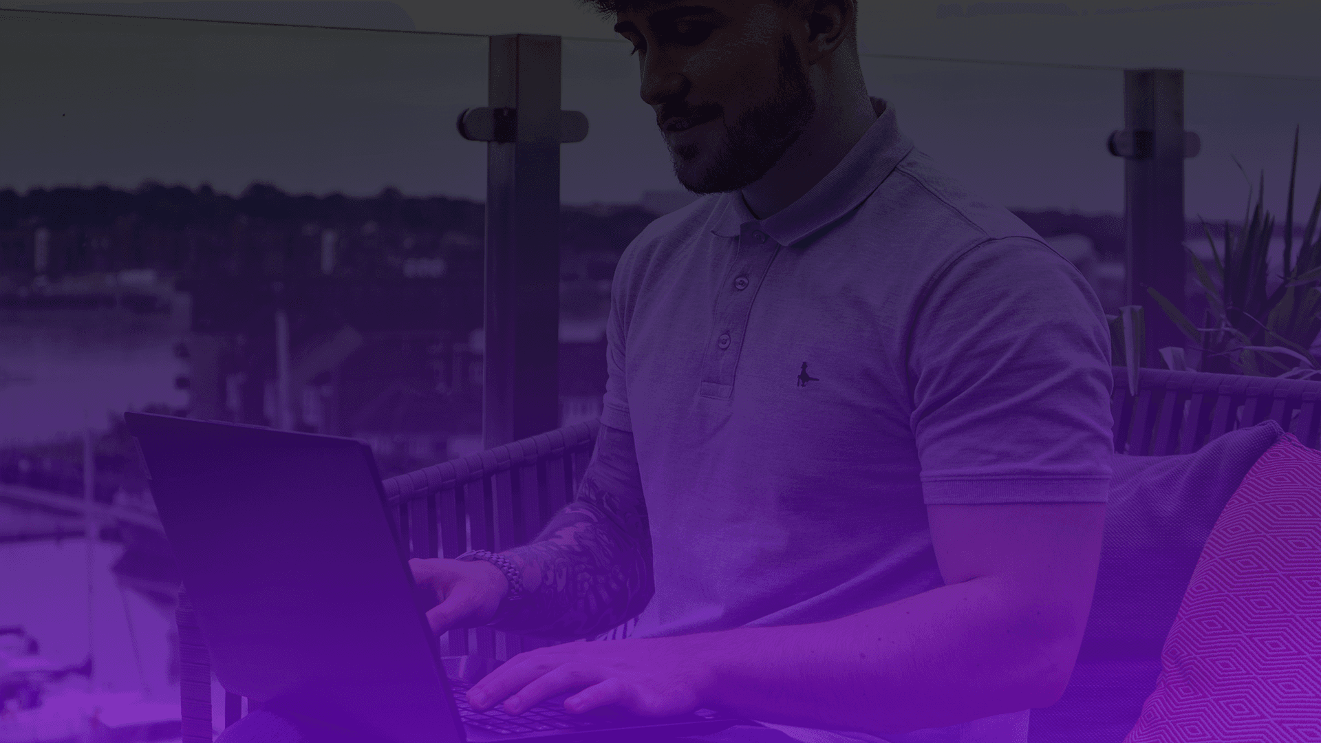 Male marketing consultant sat at laptop, helping purpose-led brands grow through meaningful marketing - Reizia Digital homepage hero banner.