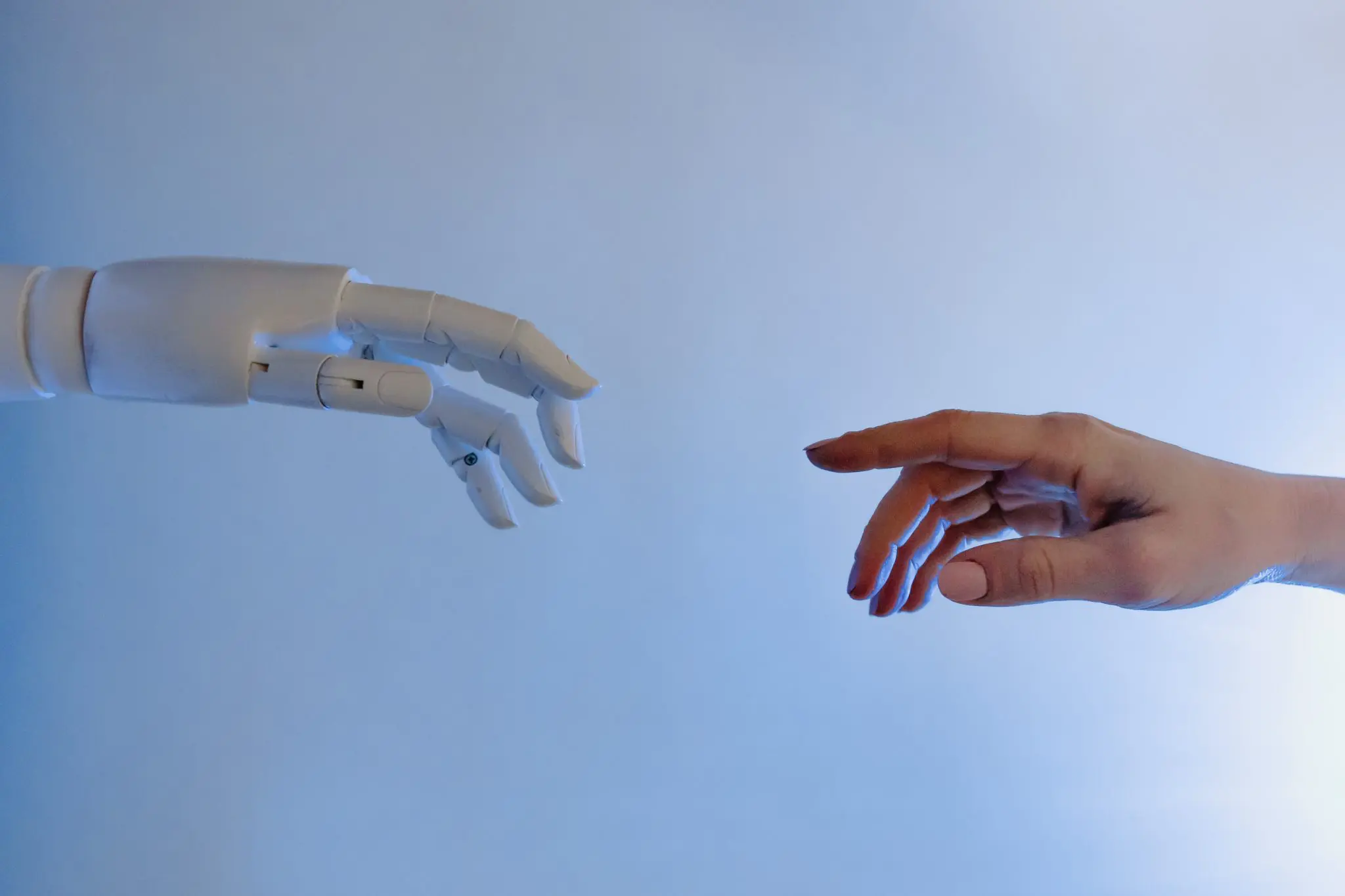 Robot and human hands, reaching out to connect with each other