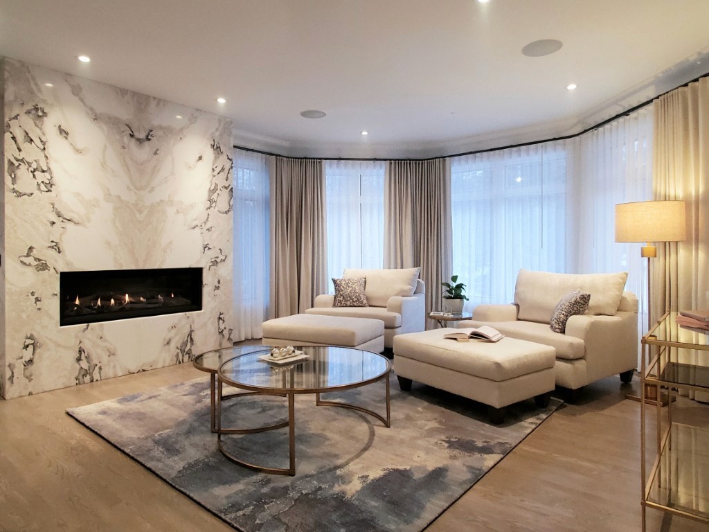 Luxurious bathroom with marble tiles, gold fixtures, and spacious freestanding tub area.