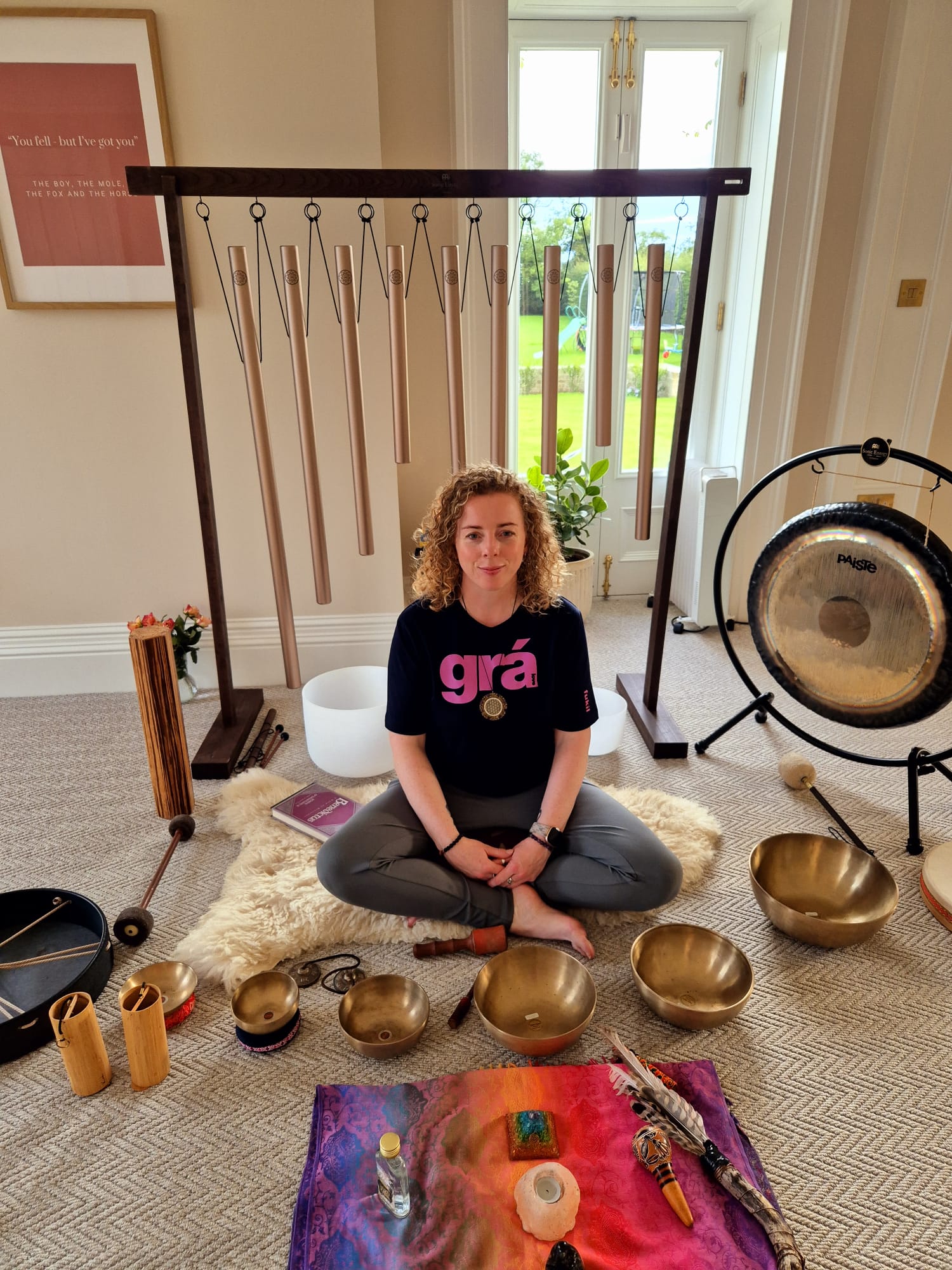 Maryrose sitting on floor surround by her sound therapy instruments