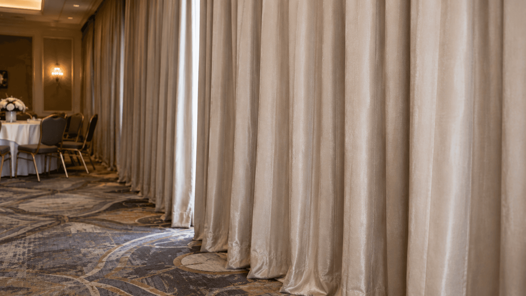 Banquet drapes in a hotel event space requiring fire-retardant treatment.