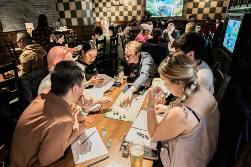 A Dungeon Master explaining a part of the D&D story to his players at Fortress Games