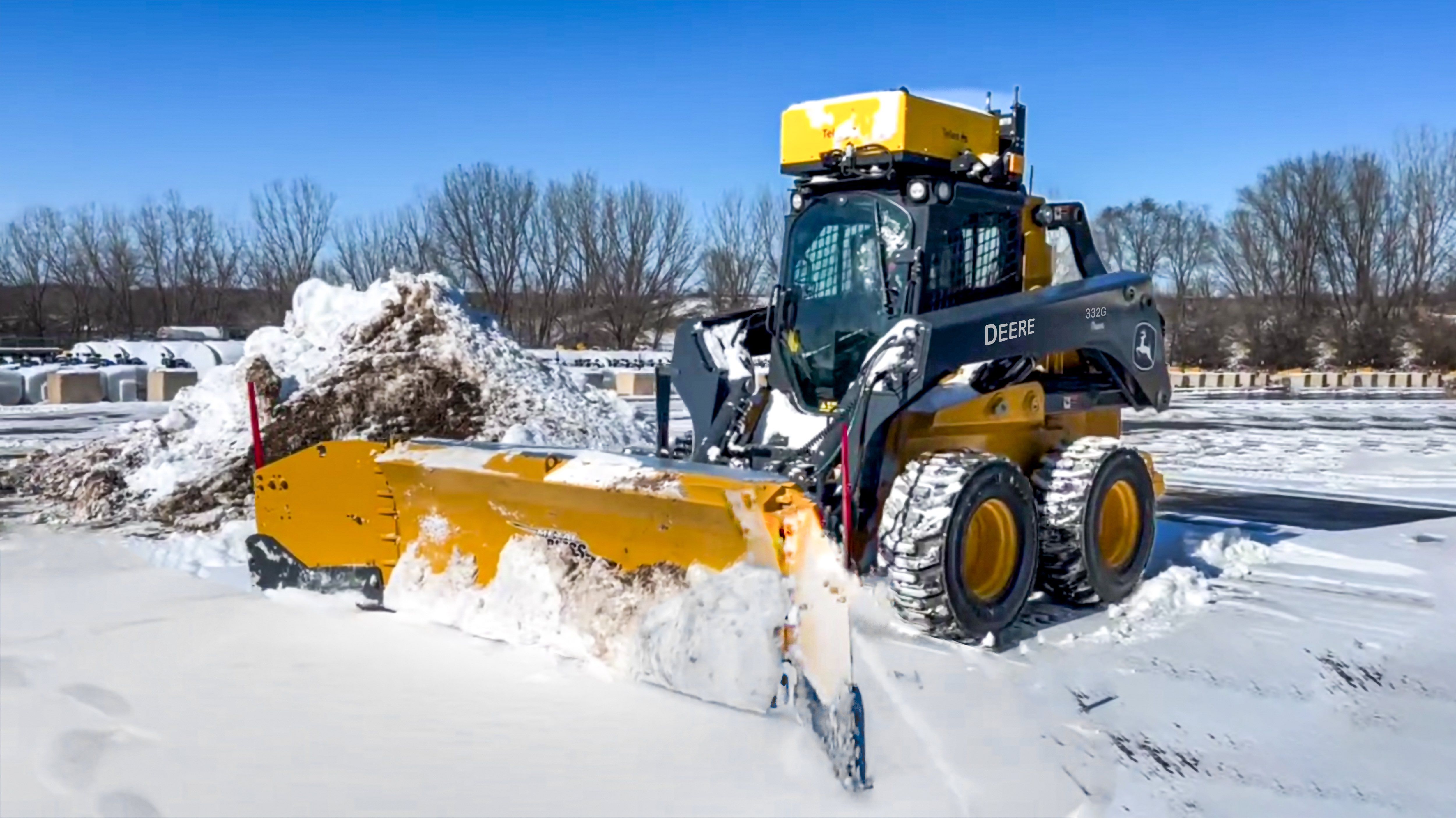 An autonomous snowplow truck removing snow on a Finnish highway during a harsh winter day.  