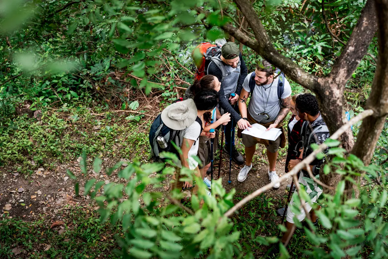 Leadership team collaborating outdoors, reviewing a map together