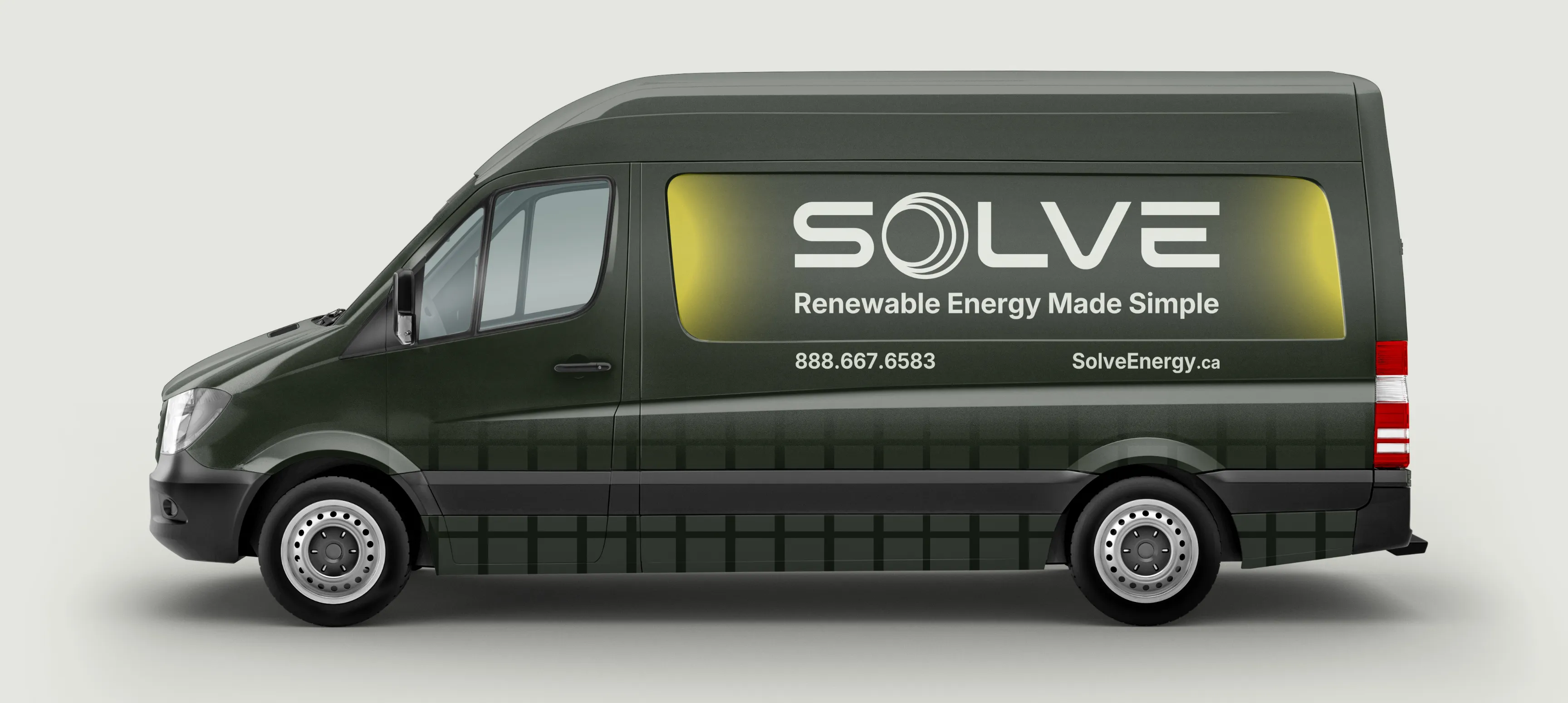 Solve Energy van mockup. The van is a dark green/charcoal with solar flares, the logo, "Renewable Energy Made Simple", their phone number, and SolveEnergy.ca