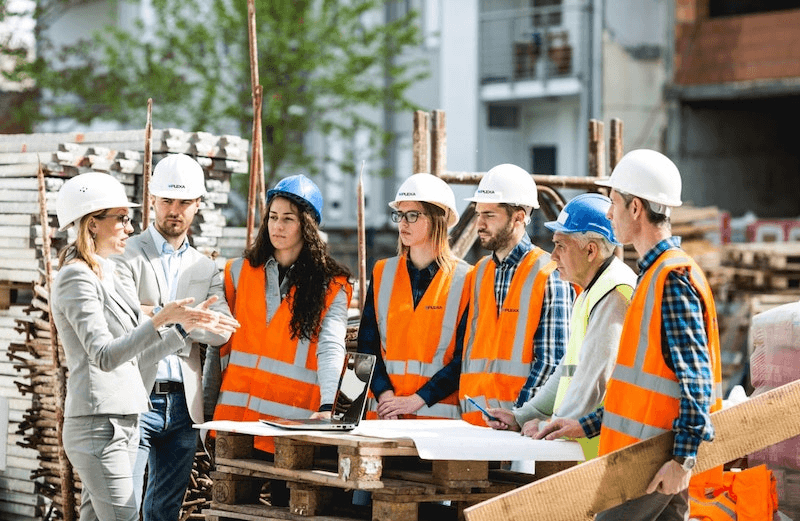 Workers around an architect talking