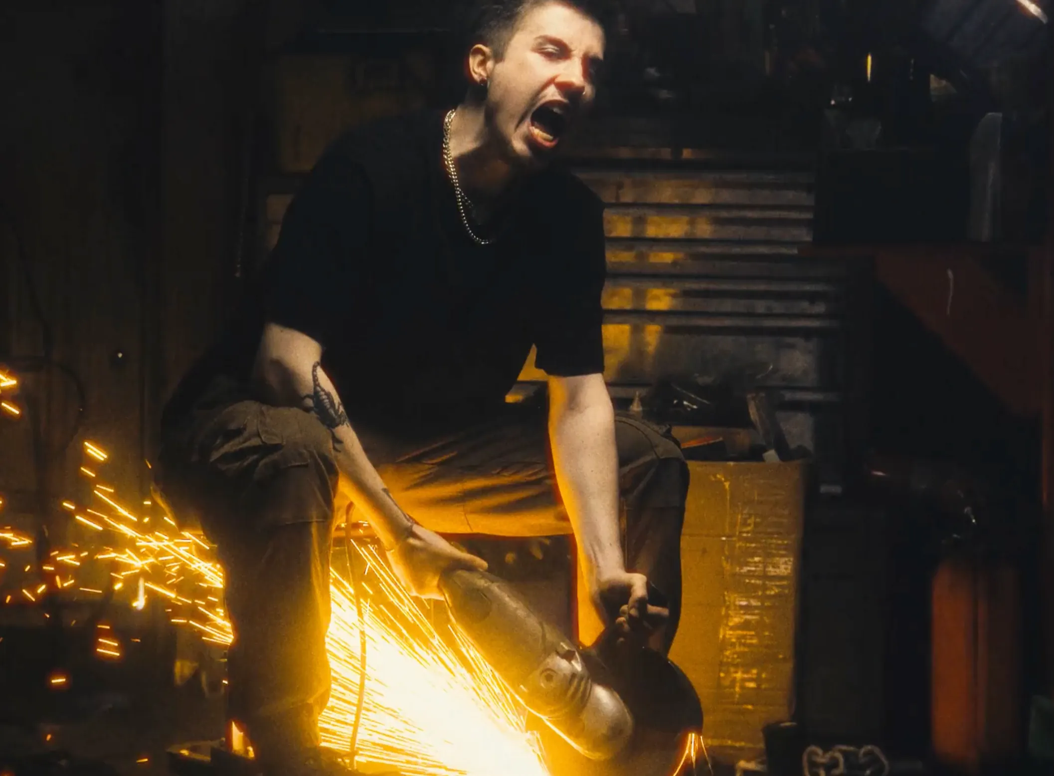 An image of a man creating sparks with a tool, shot in a studio in London by X Anima