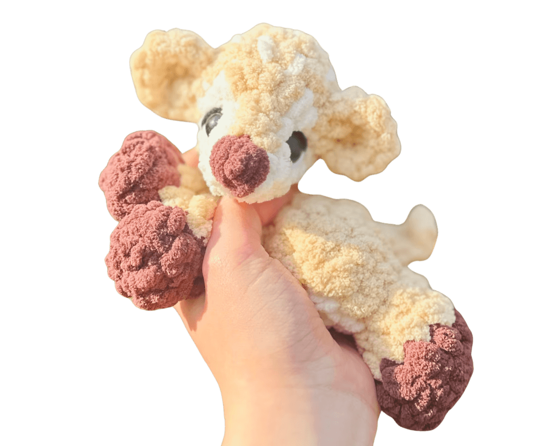 A cute, handcrafted plush hedgehog toy with brown yarn spikes and large, friendly eyes sits facing forward on a white background.