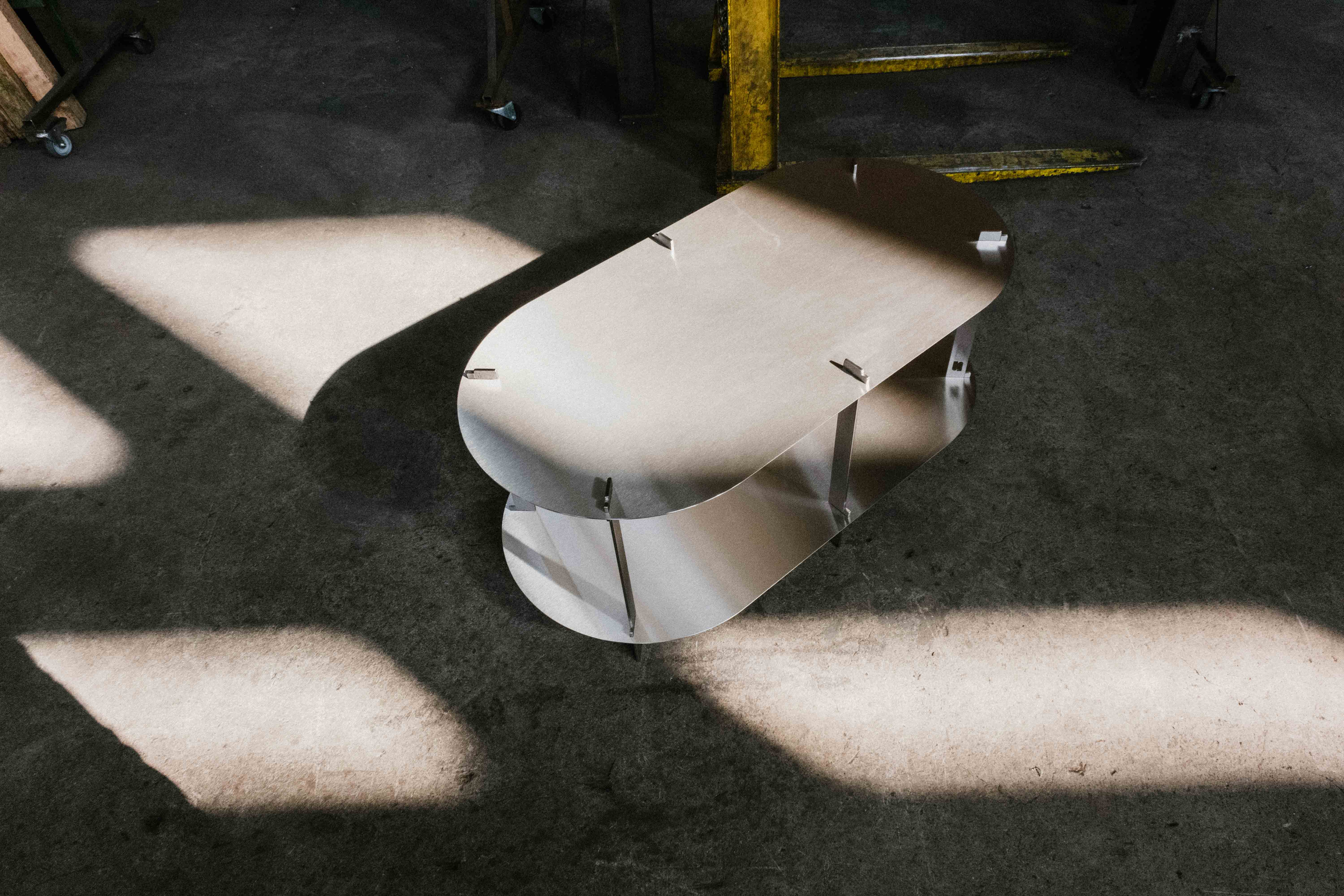 Steel Coffee Table in a workshop, sun shining on the scene