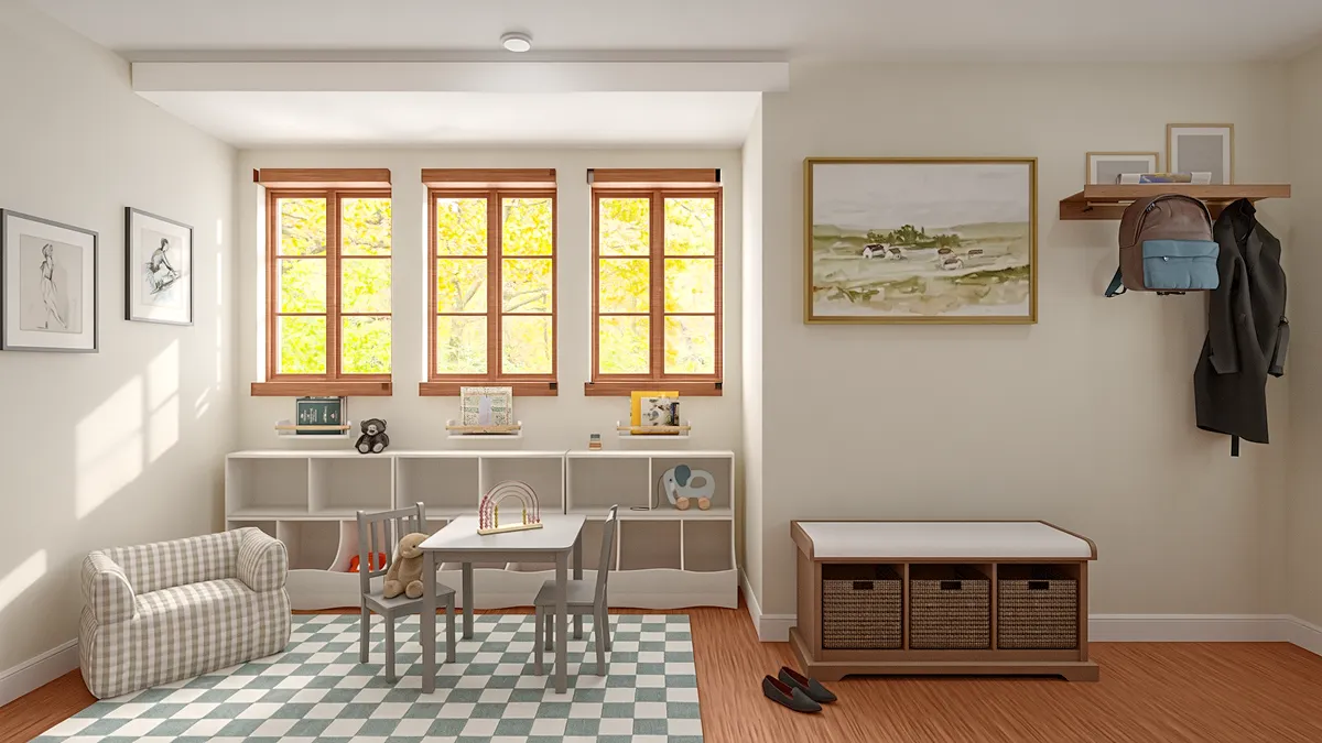 A kids' play area with a small table and low shelving, next to an entry bench with coat hooks.