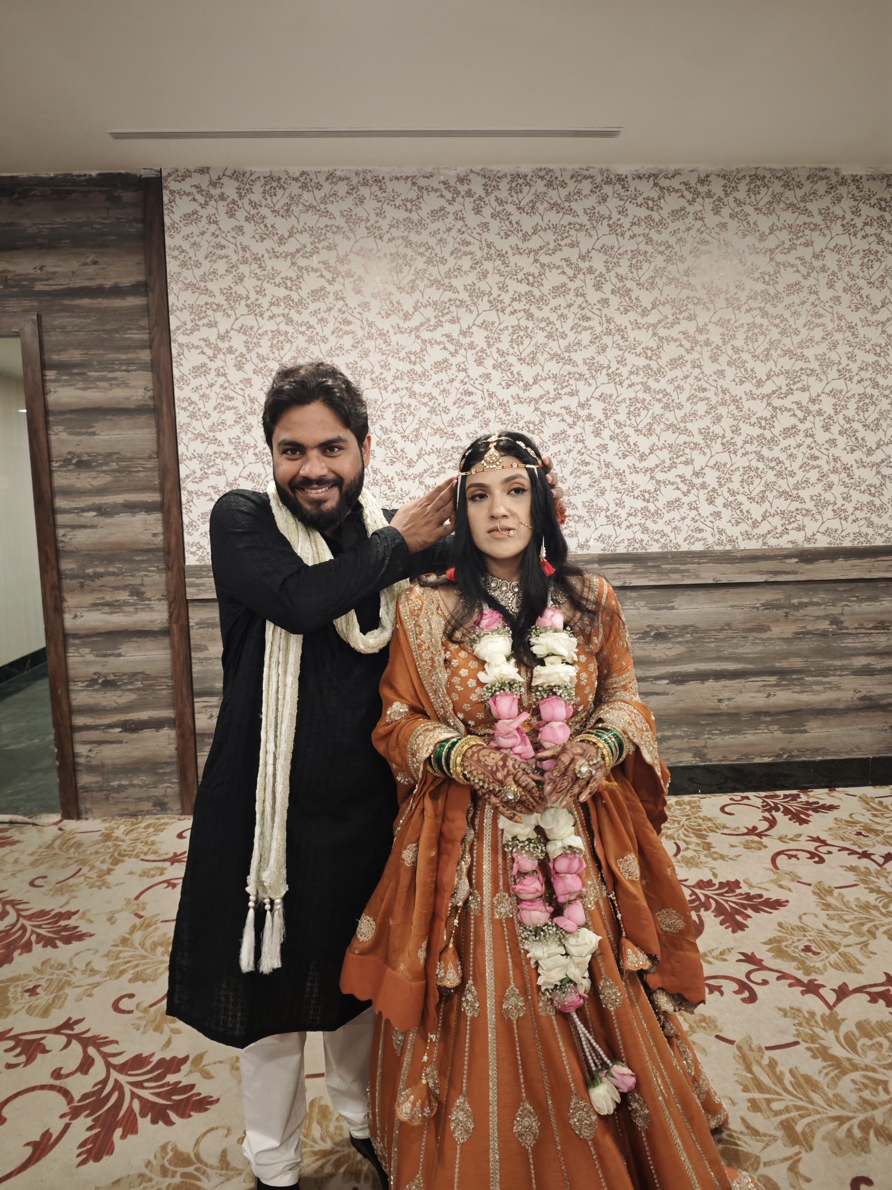 Varad gently adjusting Sarika's wedding jewellery