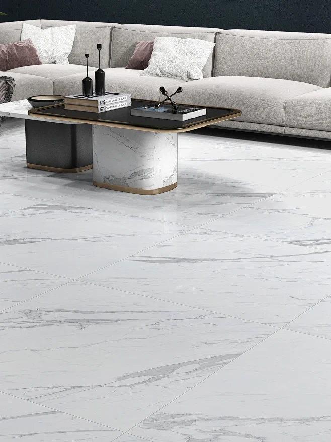 A minimalist living room with white marble floor tiles, a grey sofa, and a sleek coffee table.