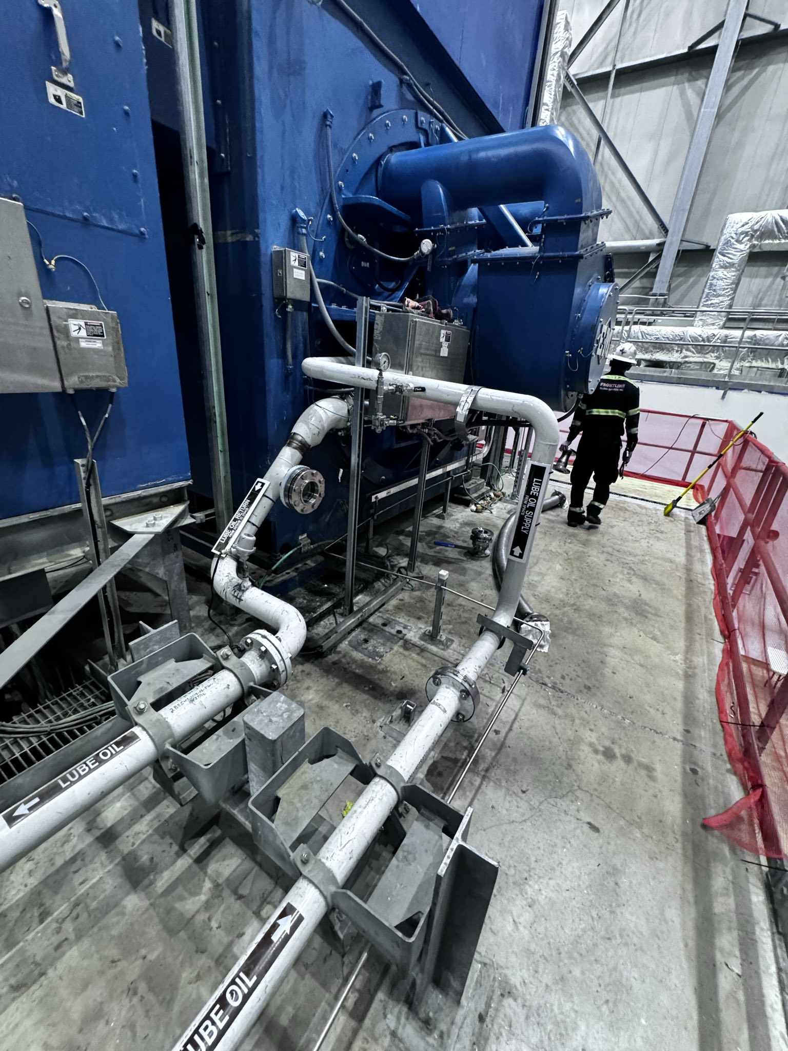 Large industrial electric motor mounted on a base plate with wiring and terminal connections.
