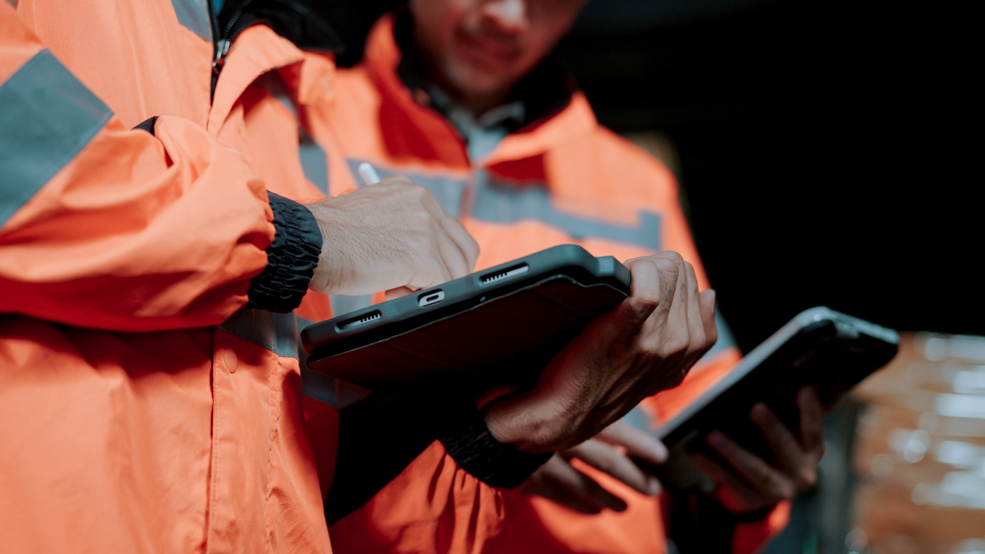 Two people signing off on warehouse compliance