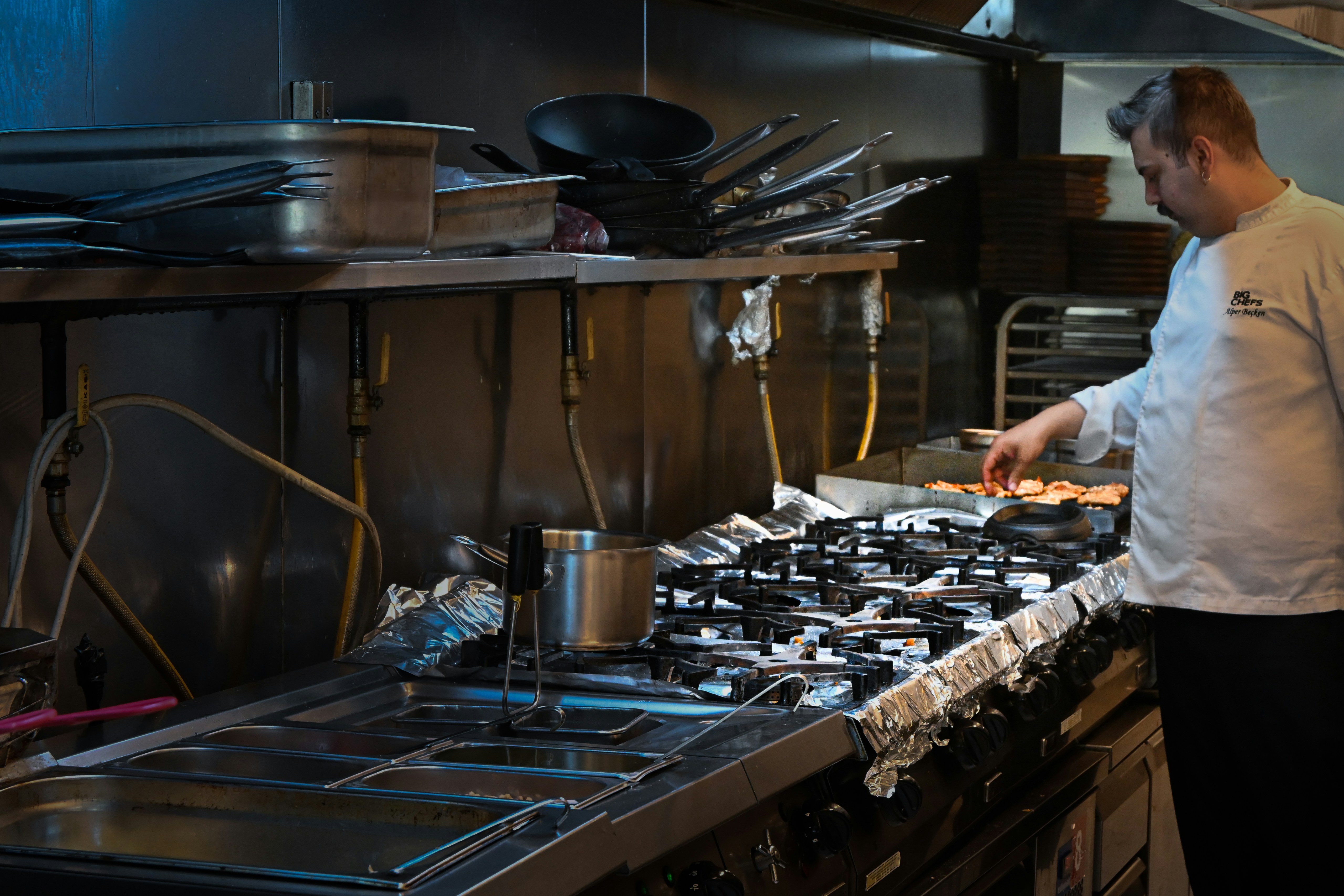 A chef cooking in a commercial kitchen