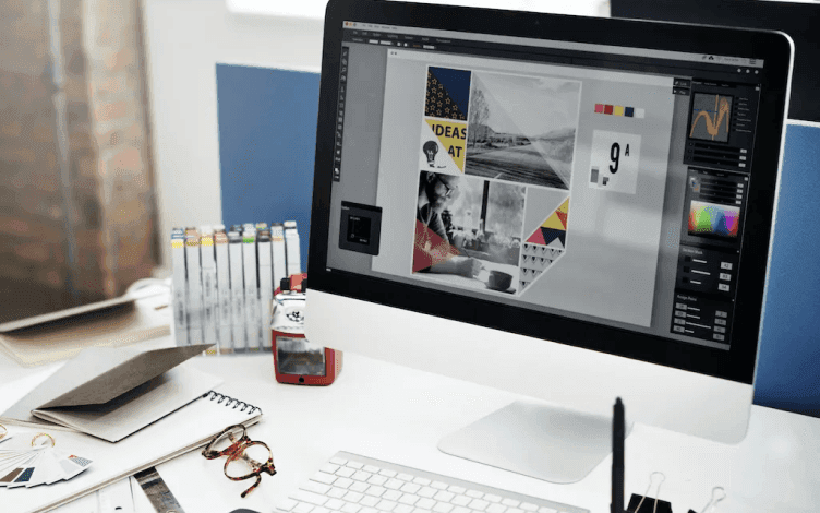 iMac on a desk with image editing software oin the screen