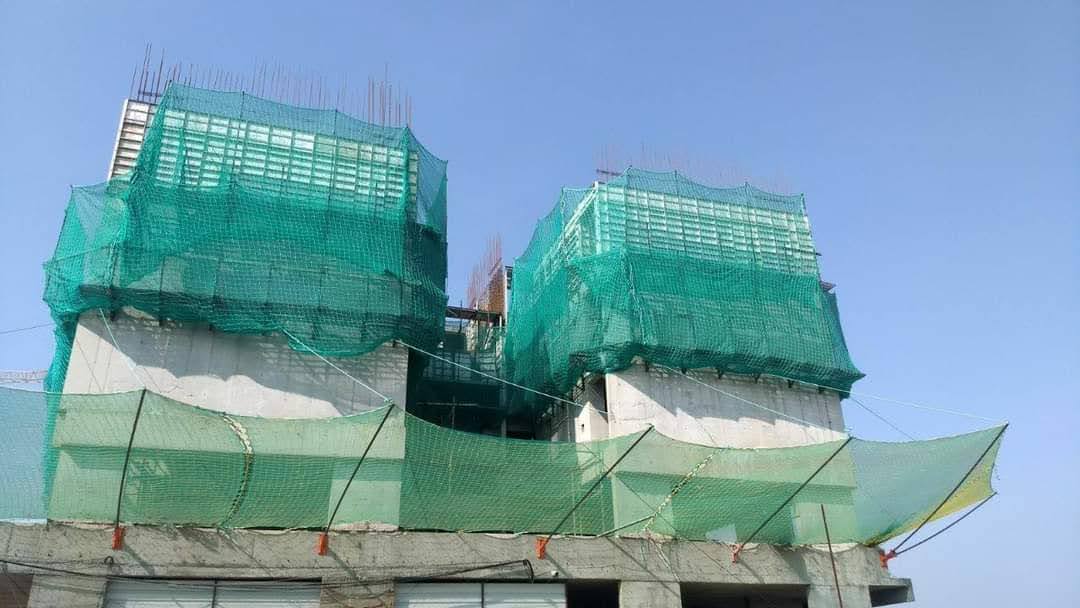 Safety net installation at high-rise construction site in kharadi
