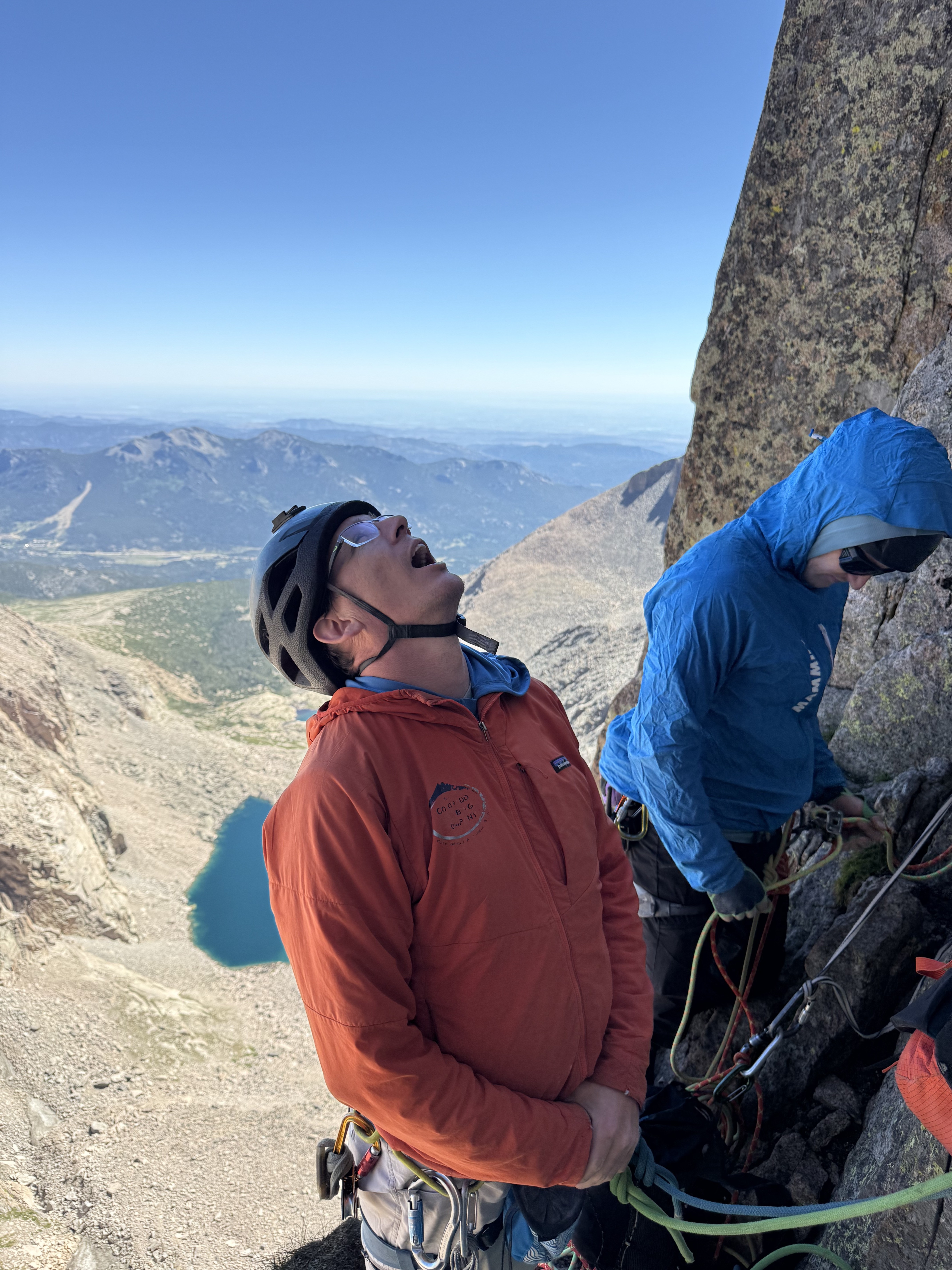 The author looks up while sharing a belay ledge with another party