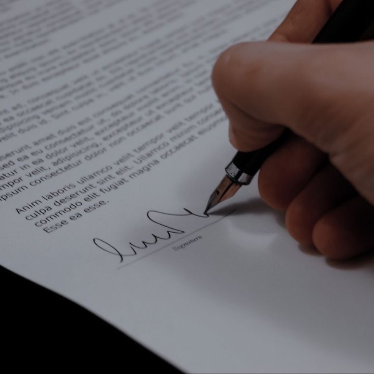 A sleek phone, likely an iPhone 16 Pro, is displayed at an angle between dark rock formations. The screen shows a futuristic design and download promo
