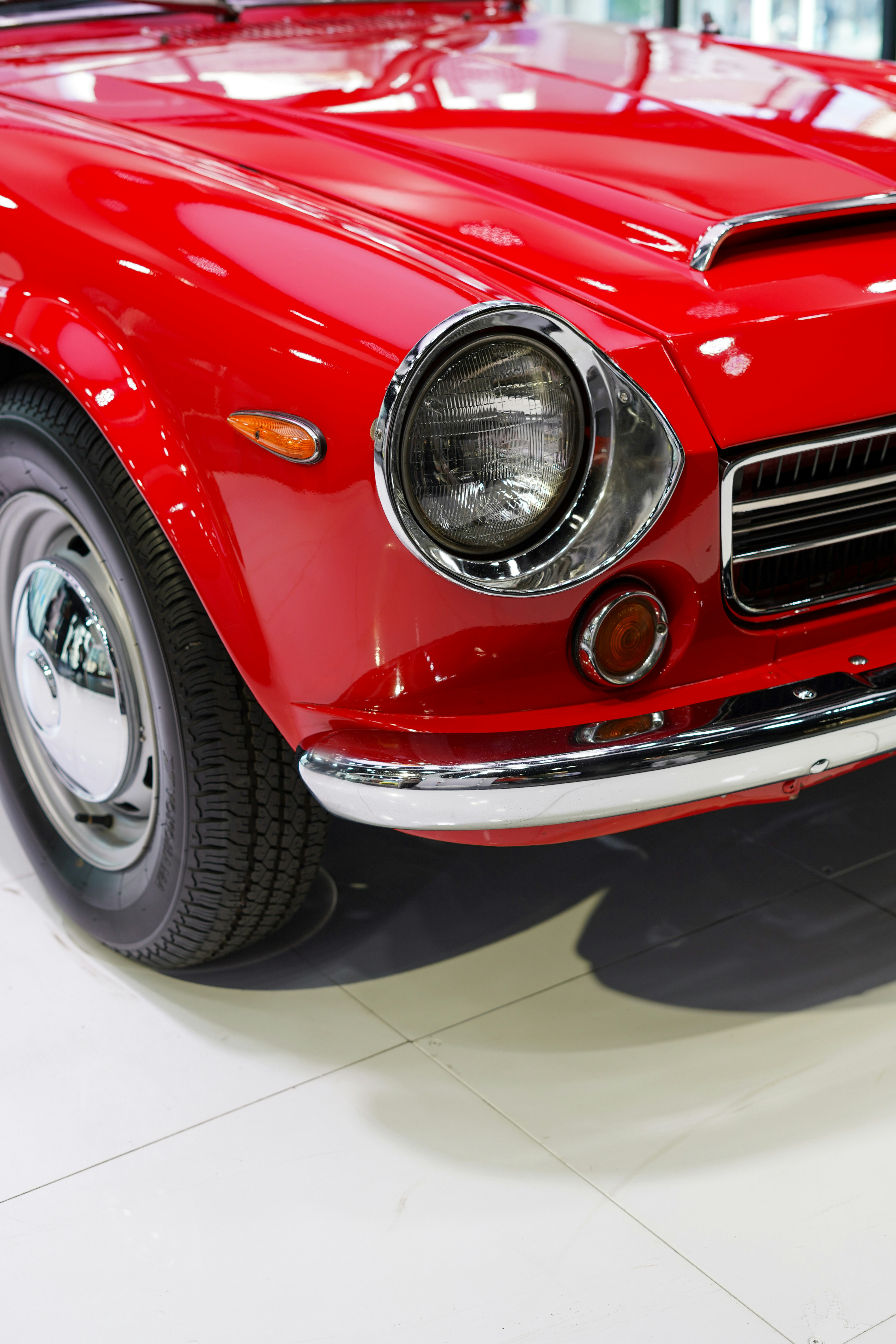 a red sports car is parked in a showroom