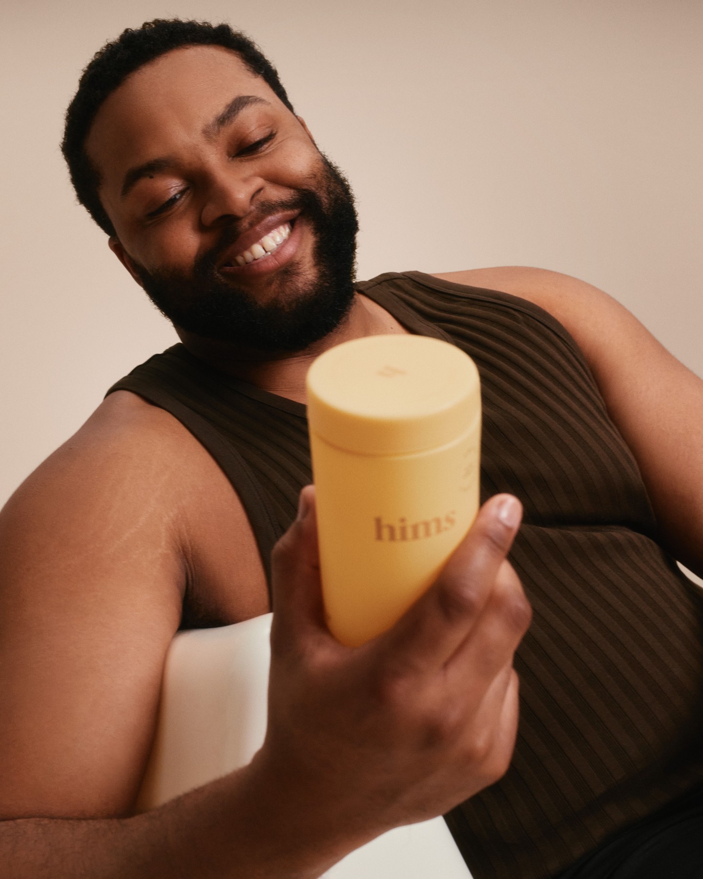 Stacked square glass jars filled with golden serum and bubbles, silver lids—luxury skincare packaging on a light background.