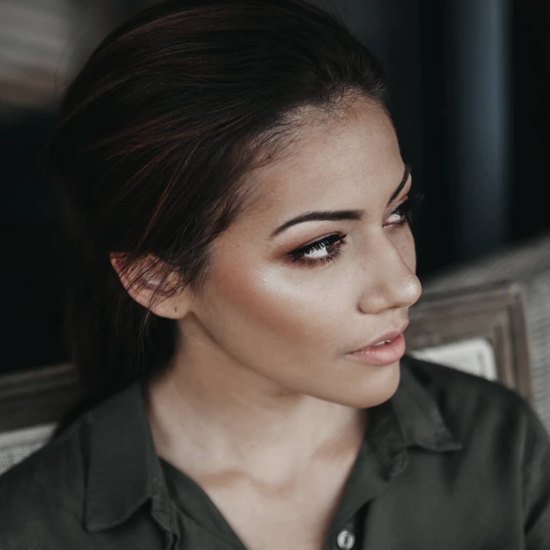 girl in a dark green shirt, after makeup