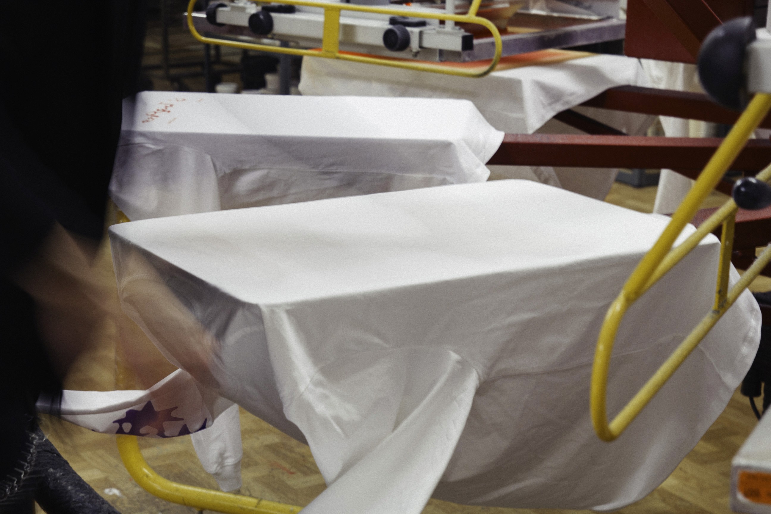 T-Shirts werden auf einem Siebdruckkarussell bedruckt