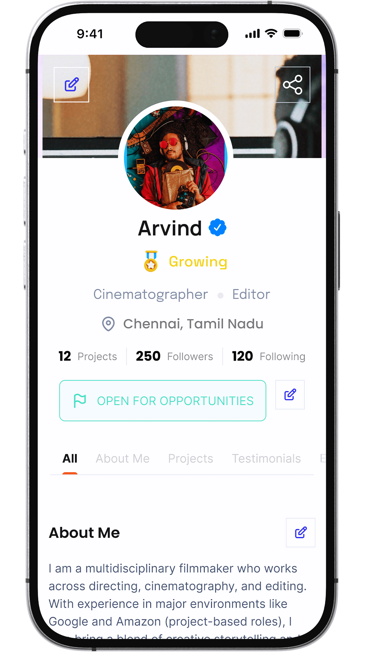 Aerial view of a winding road cutting through rocky terrain and sandy landscape.