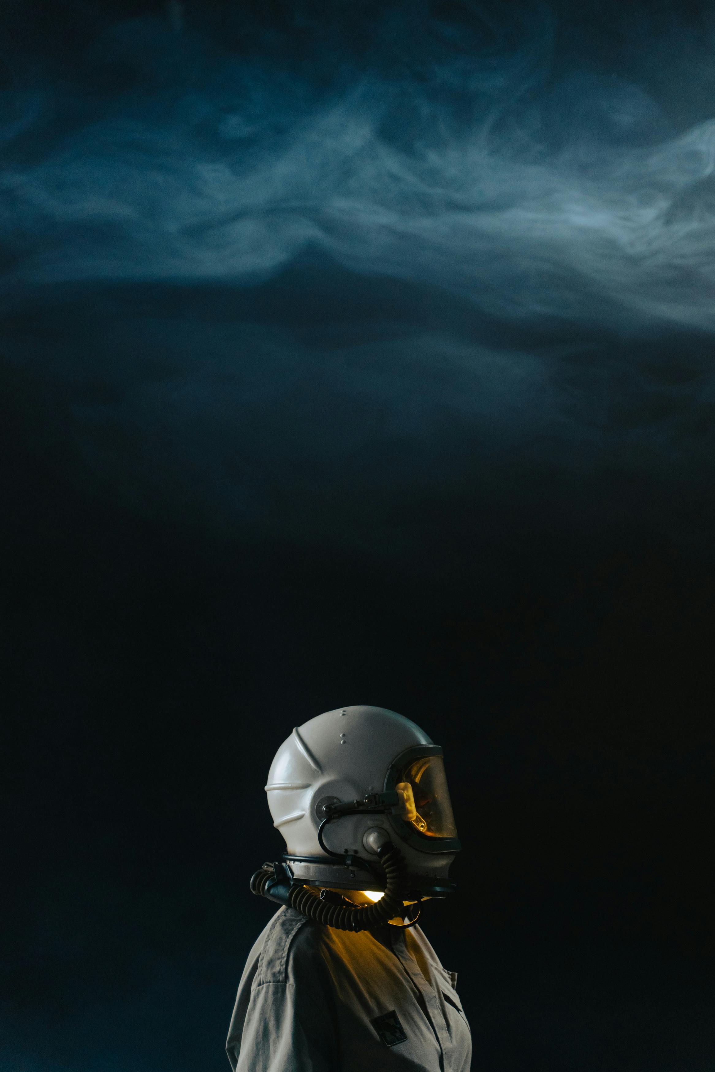 Person in Space Suit with White Helmet Standing in Outer Space