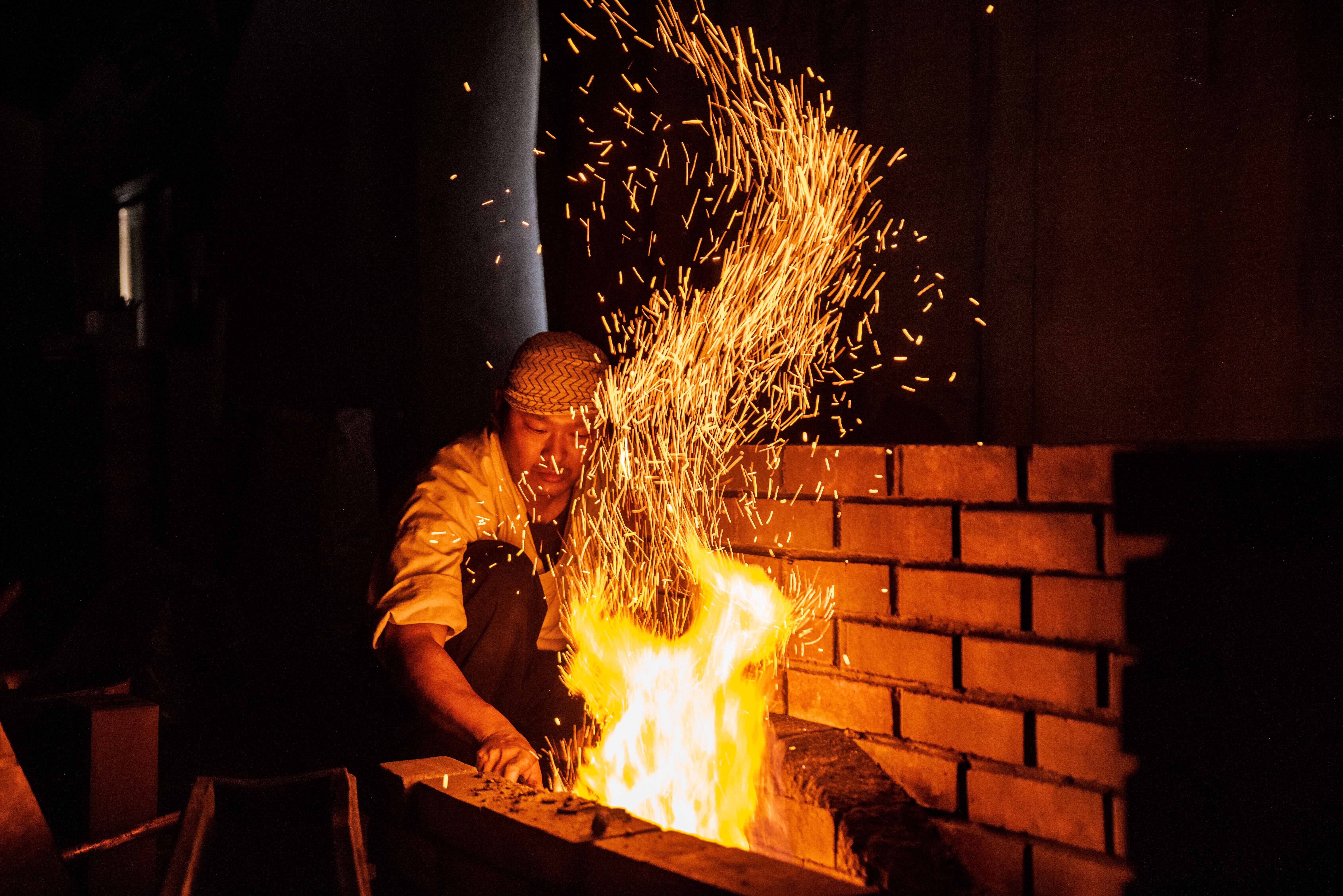 Swordsmiths hammering iron in a team