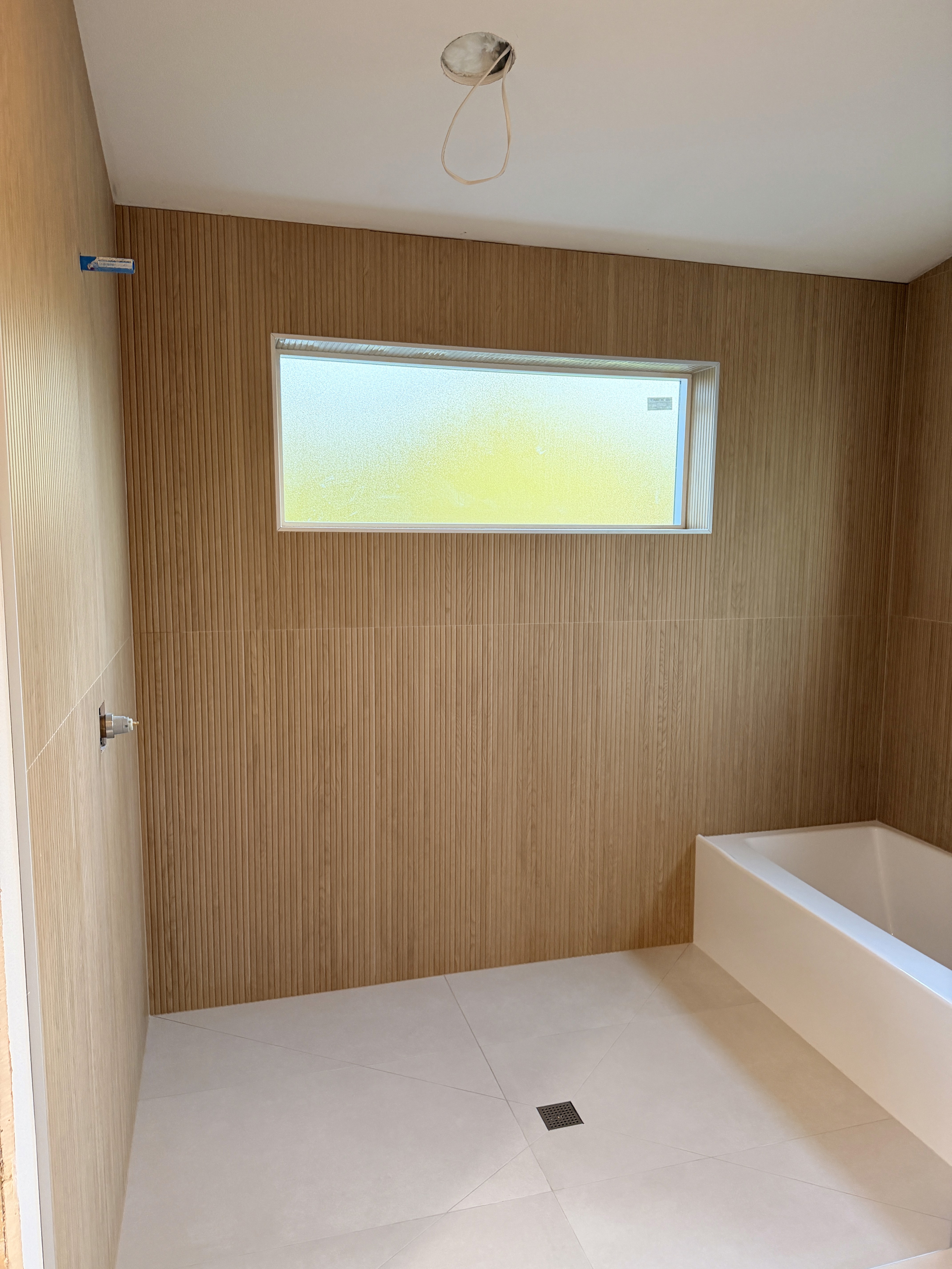Custom tiled shower with black fixtures by Dream Tiles LLC