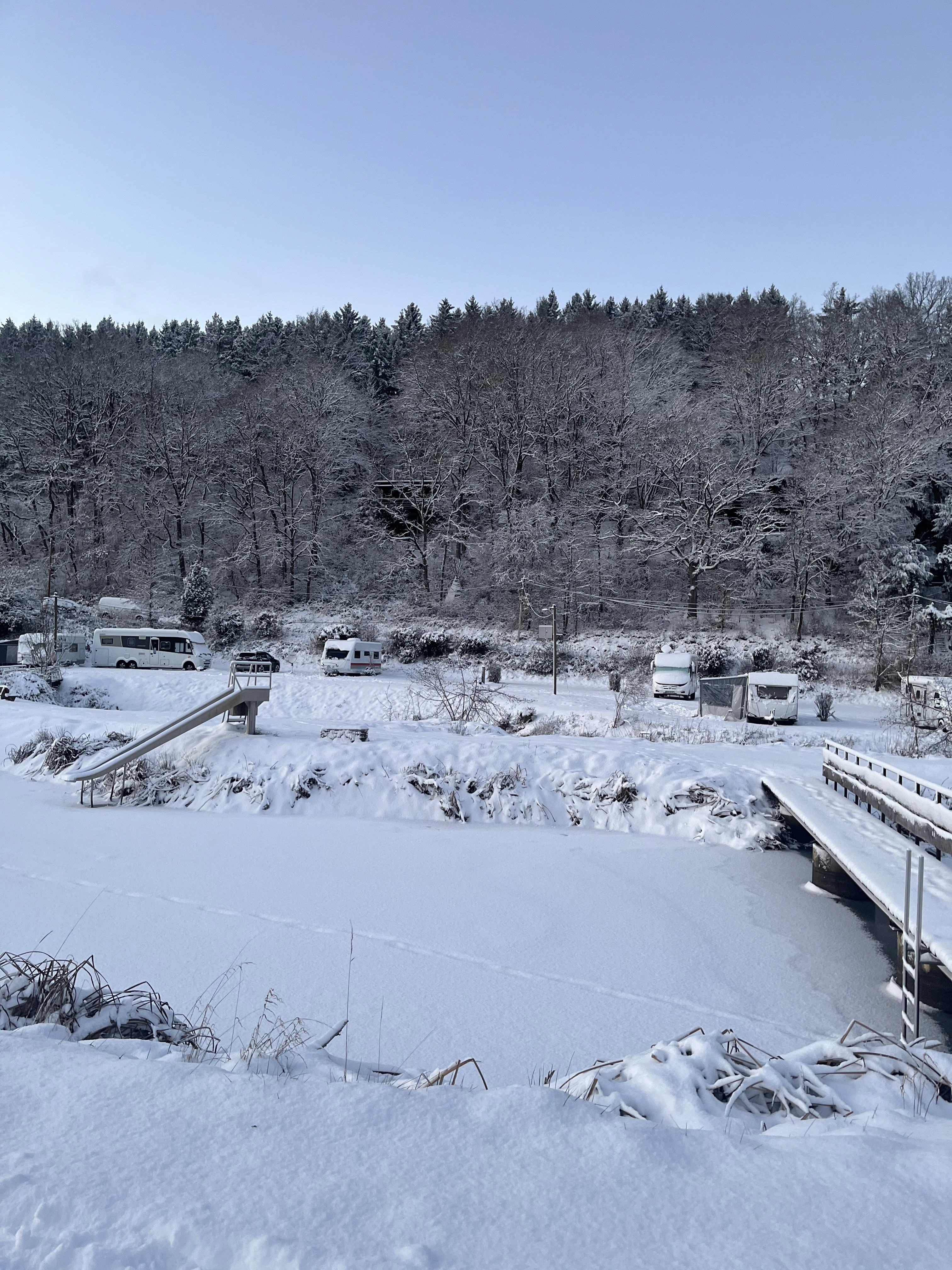 Der Badesee ist gefroheren und in weißer Winterpracht