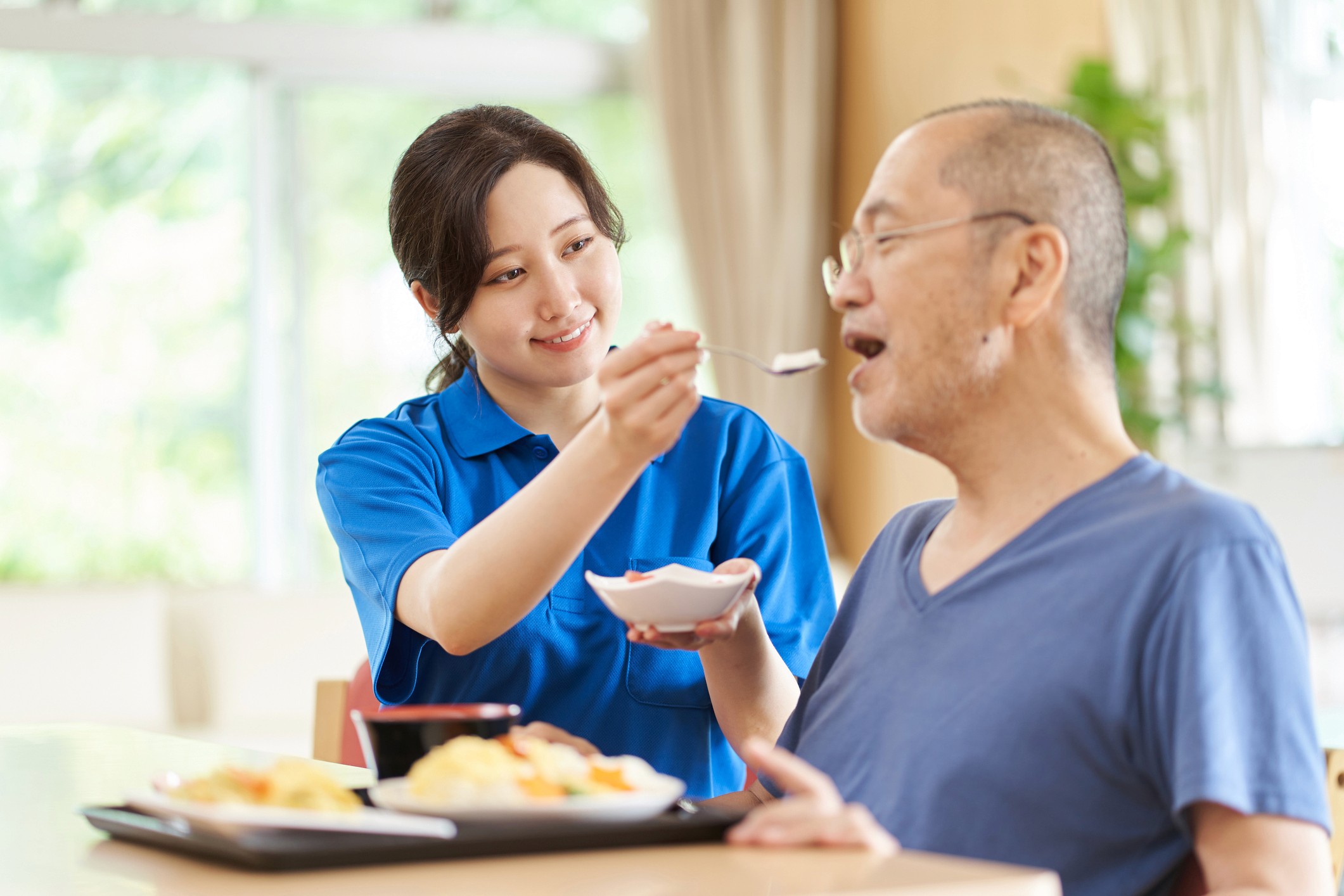 helping an older man eat