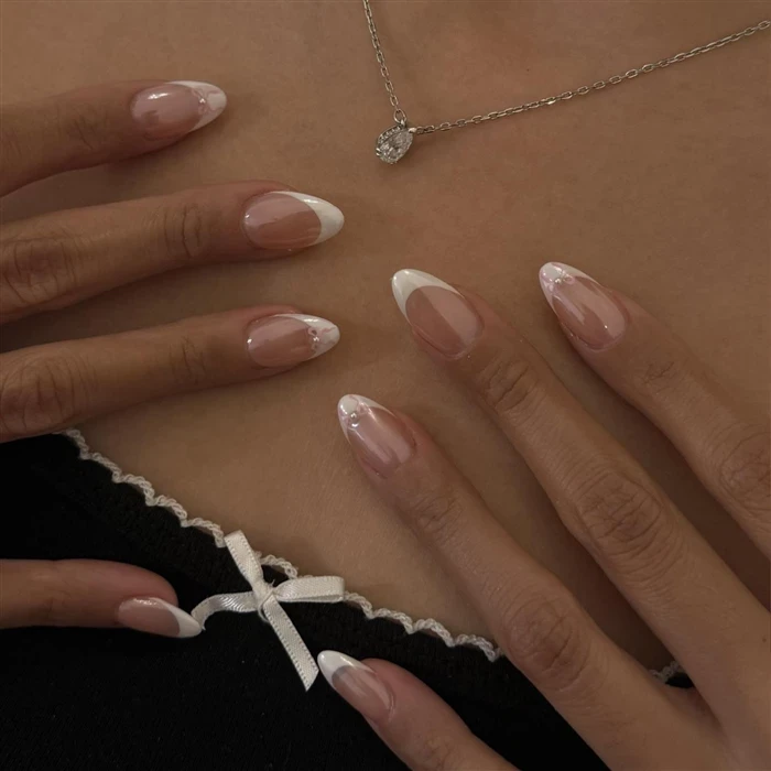 A close-up of hands performing a relaxing massage, with warm golden light illuminating the skin. The scene evokes a sense of relaxation and well-being.