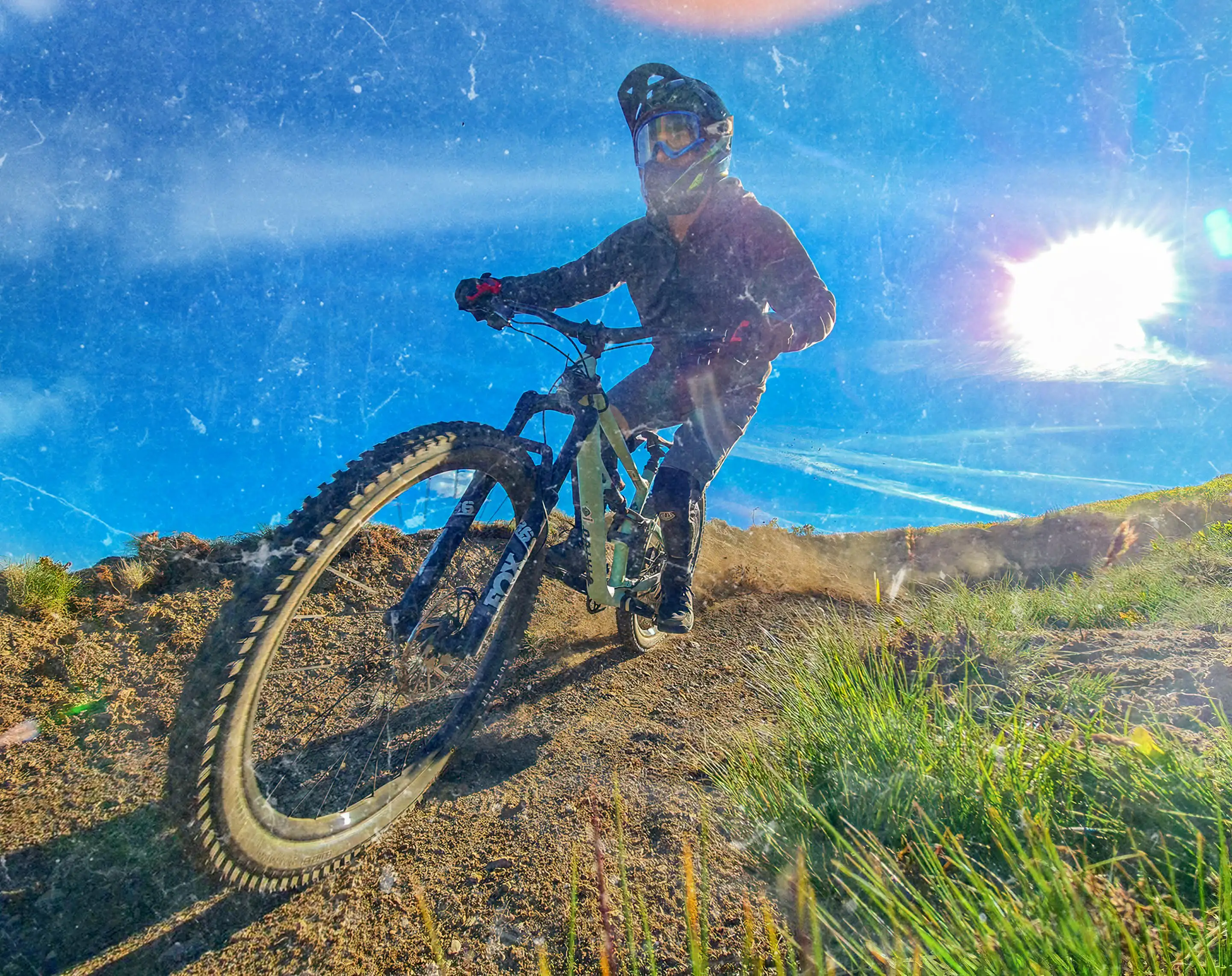Picture with a cyclist on weRIDE trails. The photo has a grunge filter applied and a blue tint.