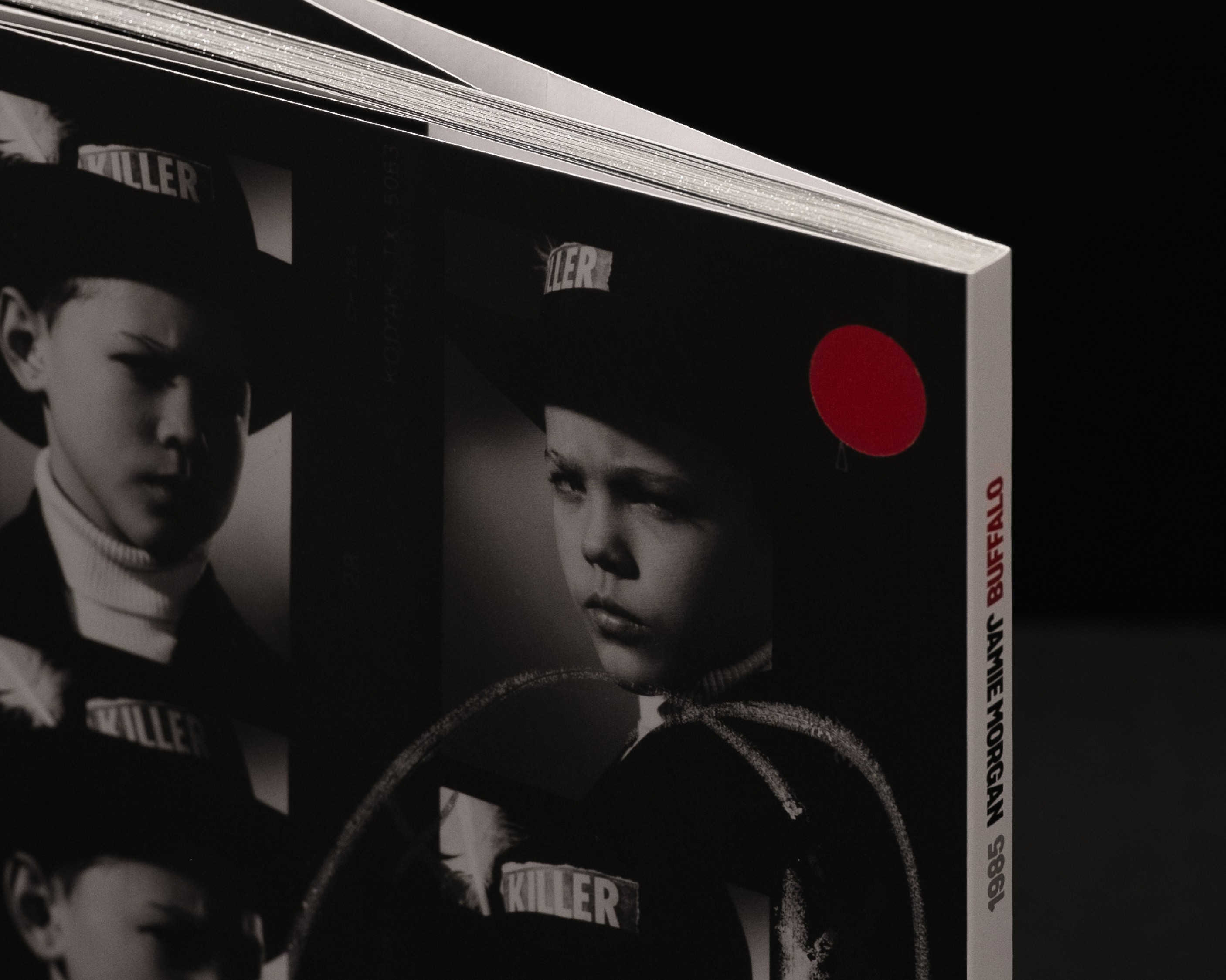 Black and white portraits of Felix Howard displayed on a page, featuring two individuals with a red circle accent in the corner.