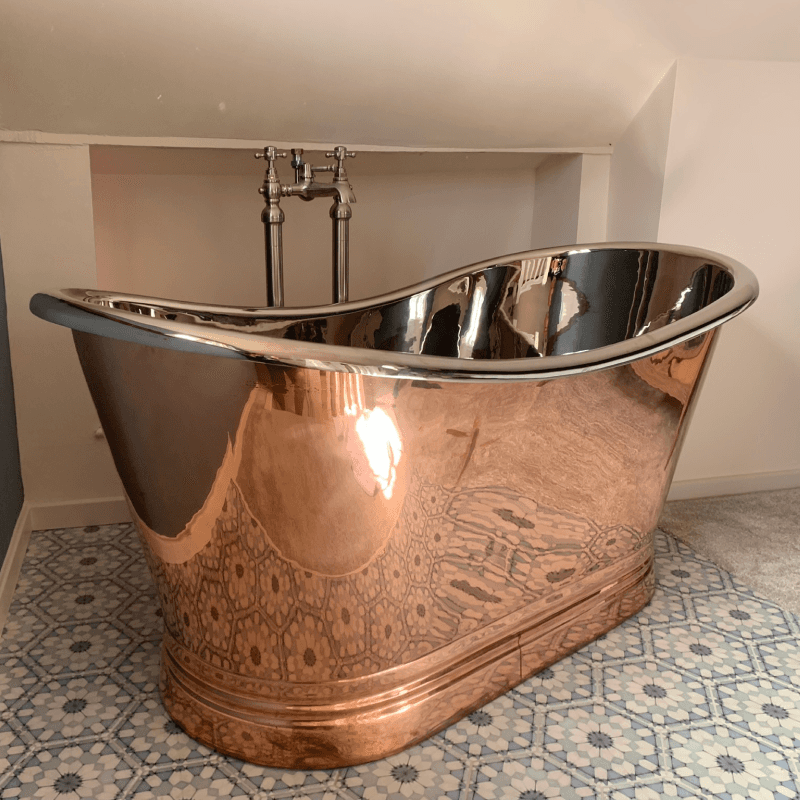 Luxury copper bath in tiled bathroom