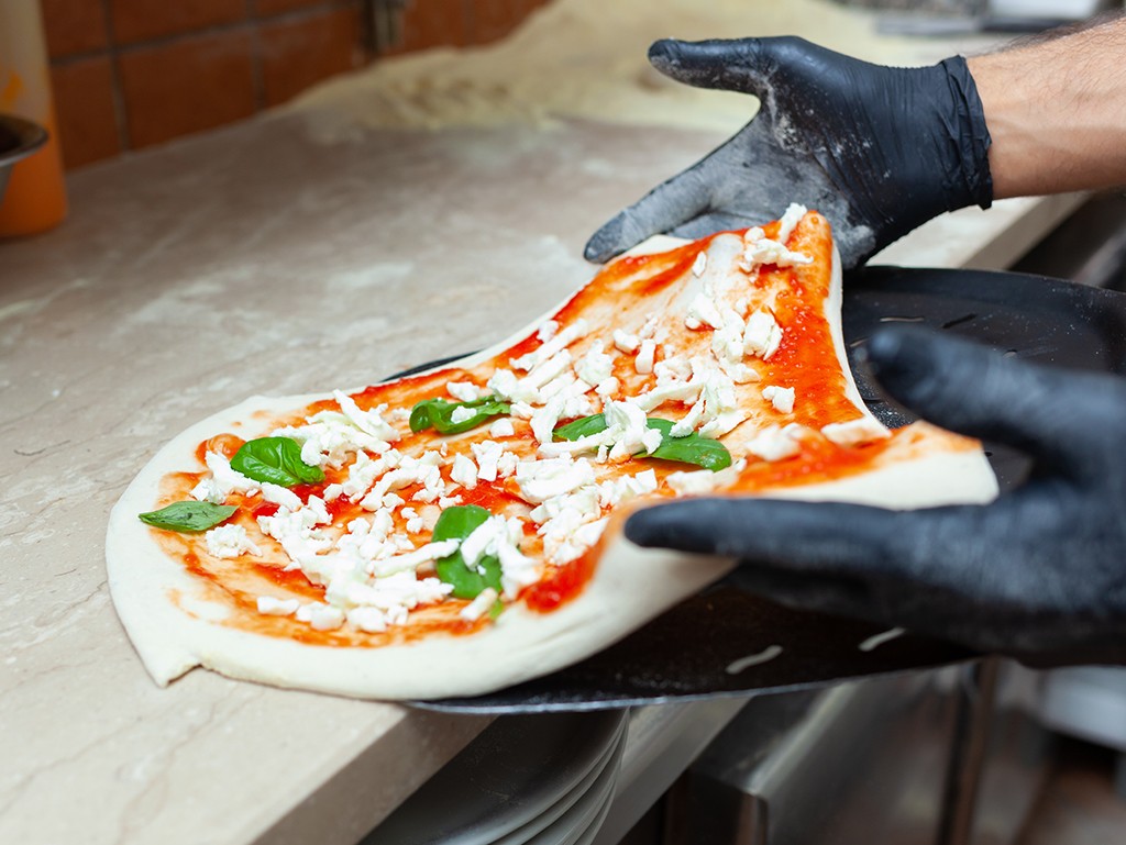 man holding up pizza peel