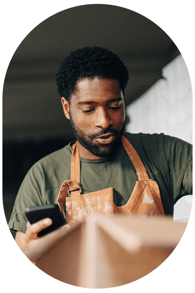 Worker checking off contents of box with phone