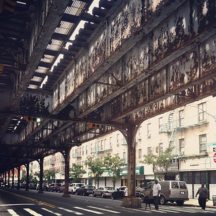 photo pf a railroad bridge and street view