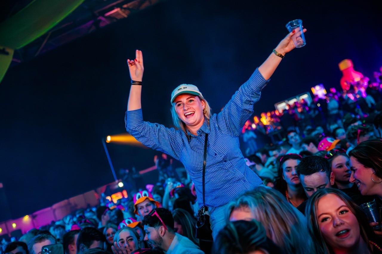 woman dancing on shoulders at music festival